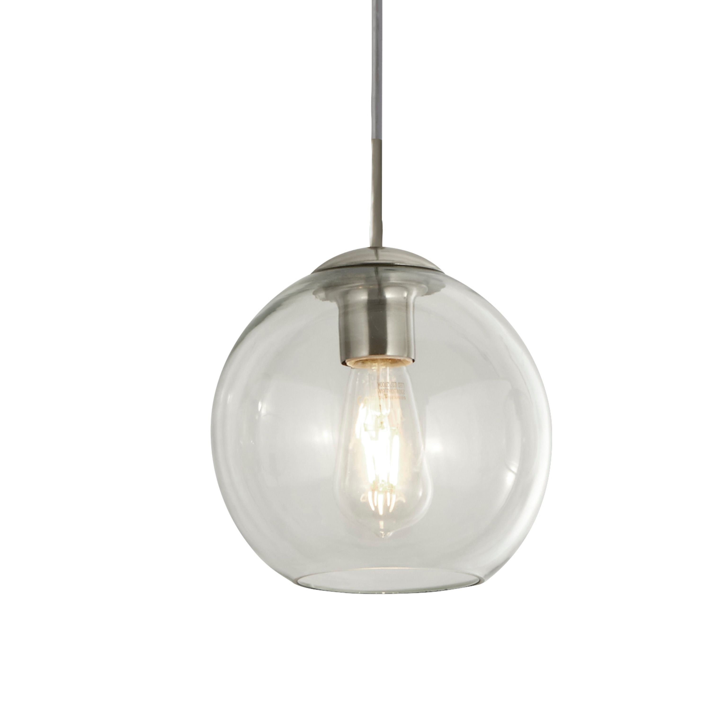 Close up of one clear glass globe shade on the Balls pendant, showing the chrome fitting and a lit LED filament bulb inside