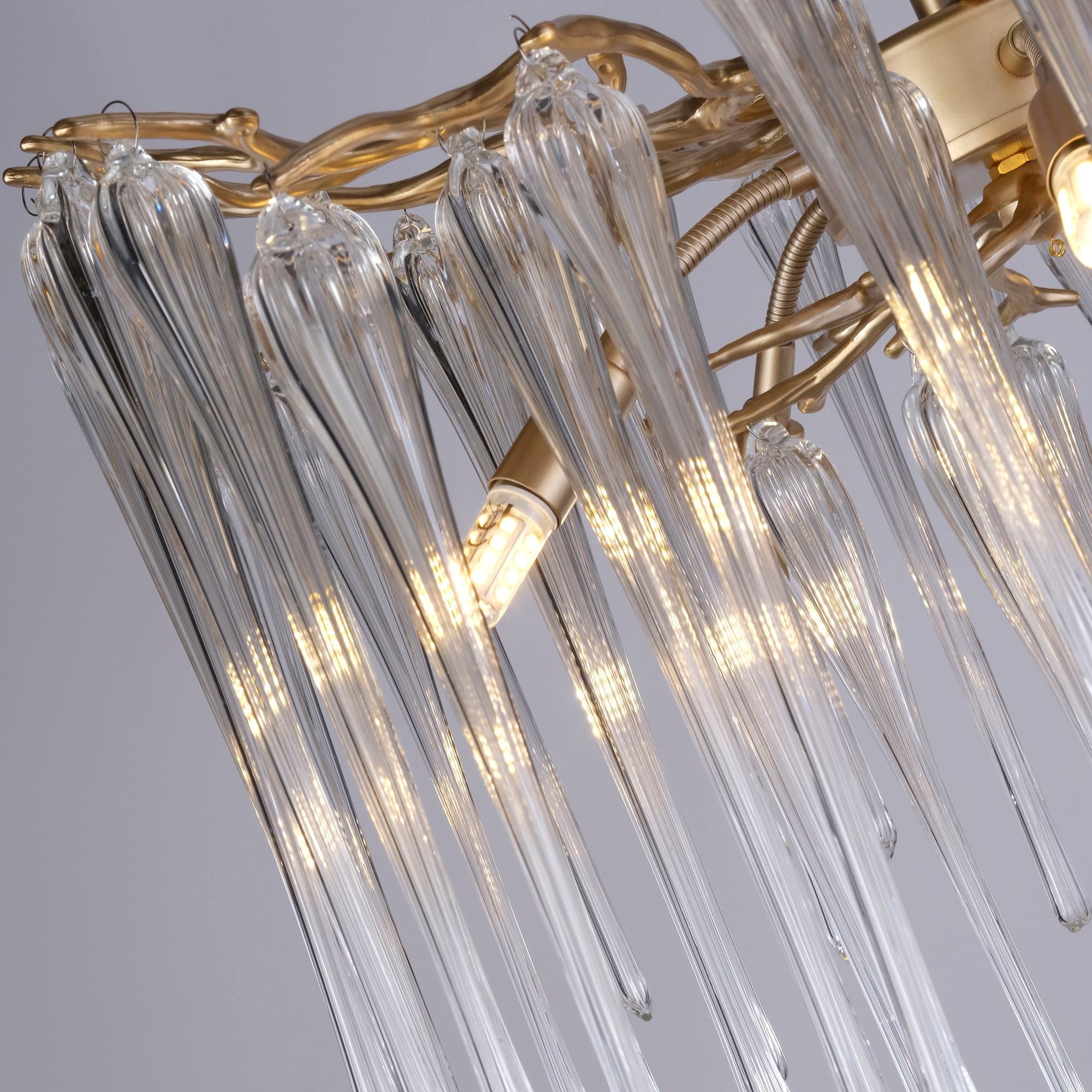 Close up of the gold branch frame and glass drops on the Searchlight Heritage 5 light pendant, showing the G9 bulb fittings