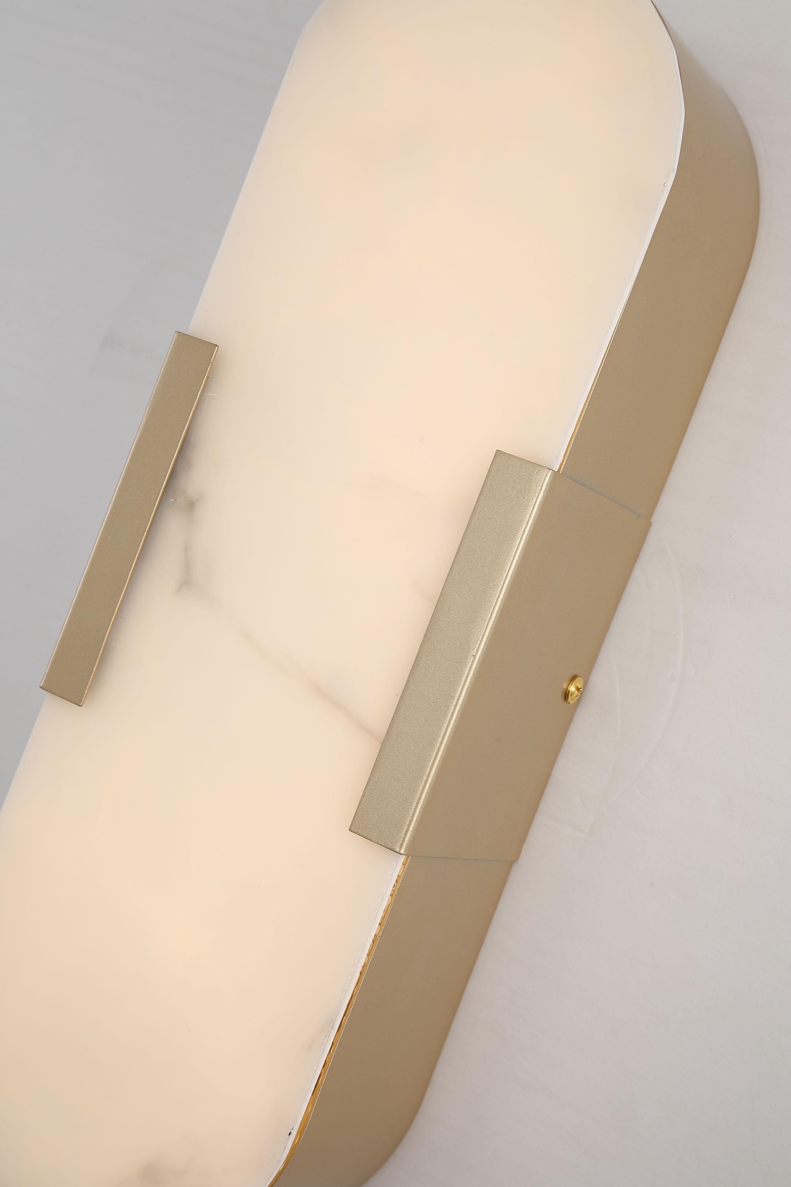 Close up of the marble effect resin shade and matt gold frame clip on the Opaline wall light, showing the veined texture