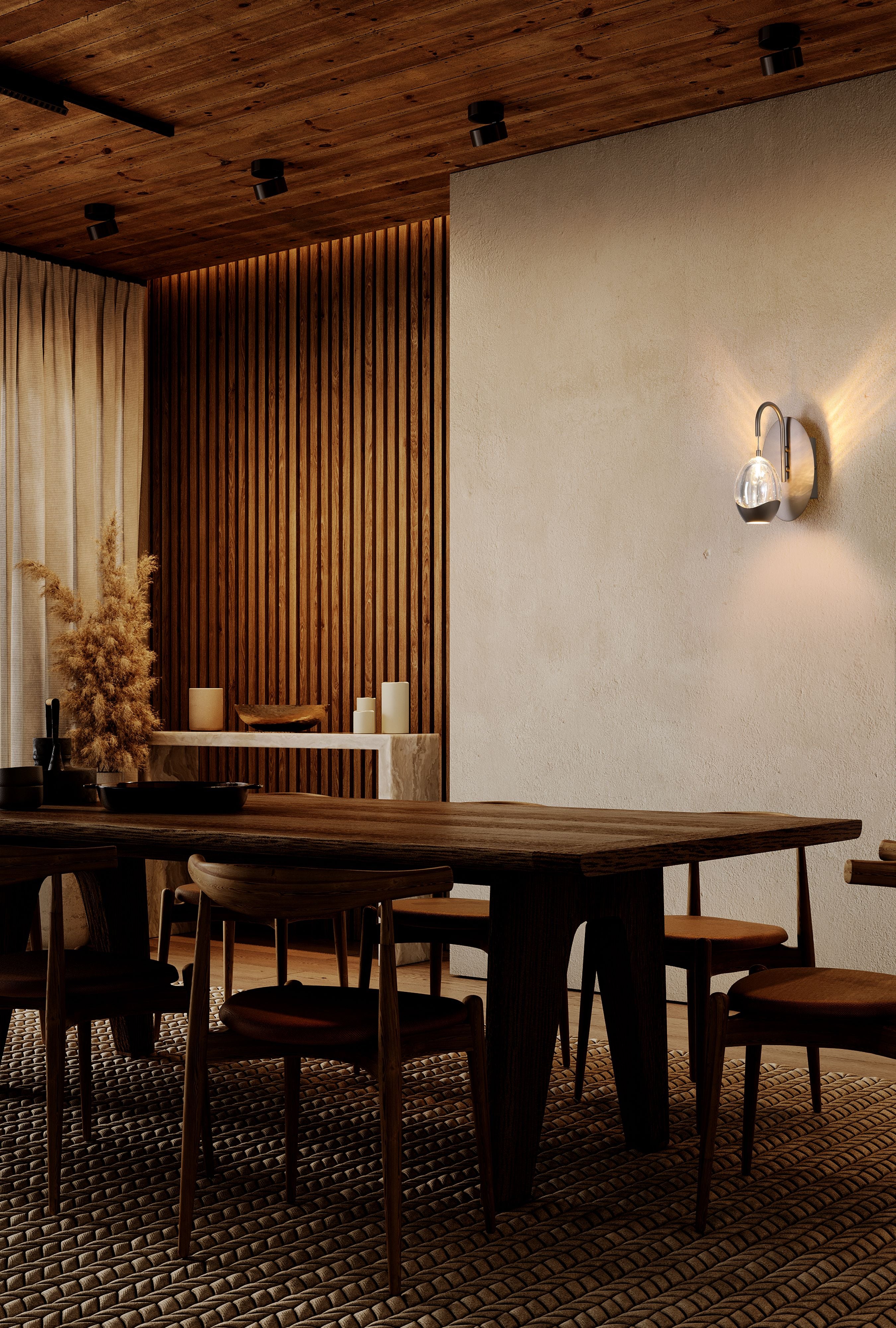 Searchlight Seeds 1 Light Wall Light styled on a wall above a dark wood dining table, shade lit warm white