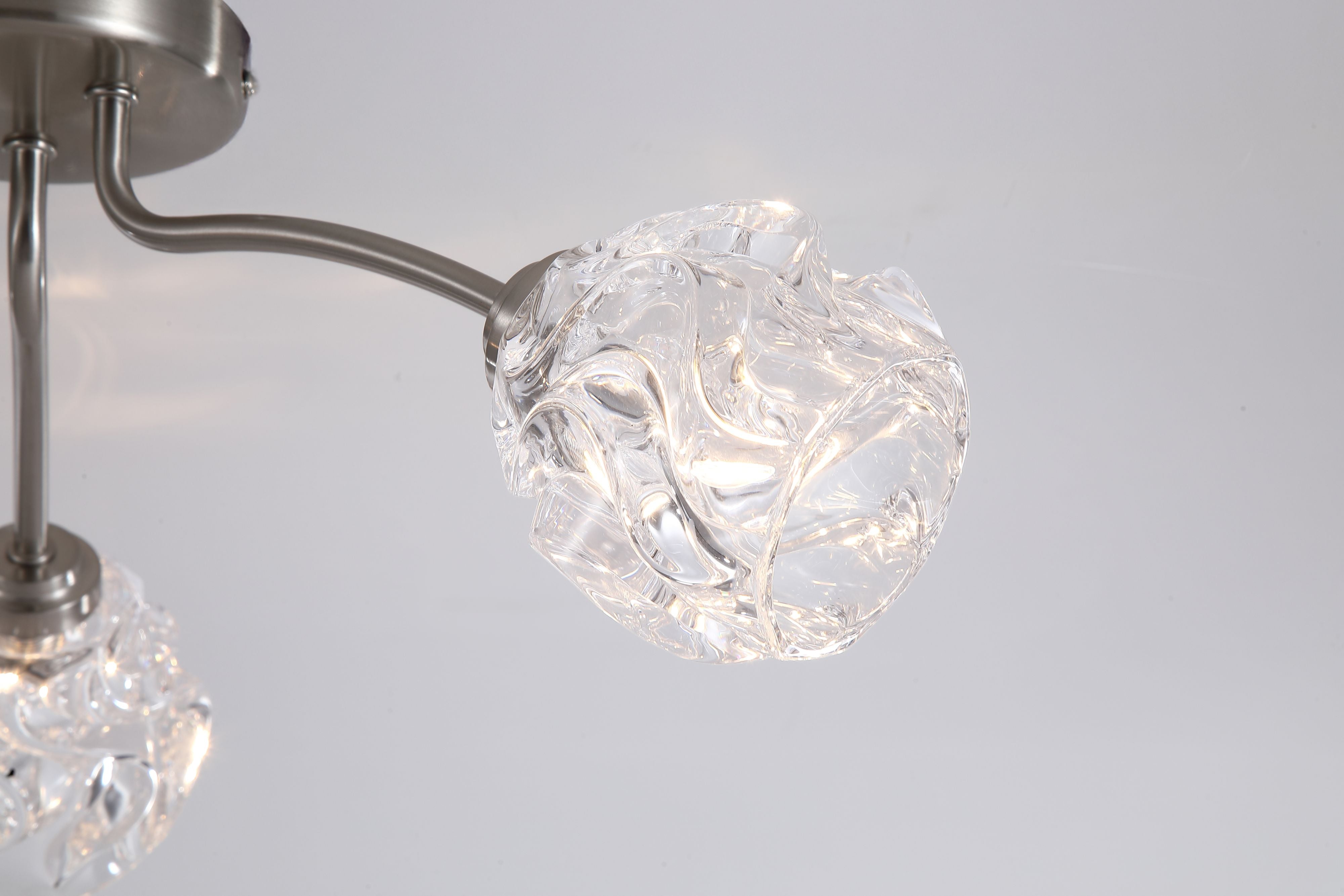 Close up of a crumpled clear glass shade on the Searchlight Astral 3 light flush ceiling light in satin nickel, showing the textured glass detail