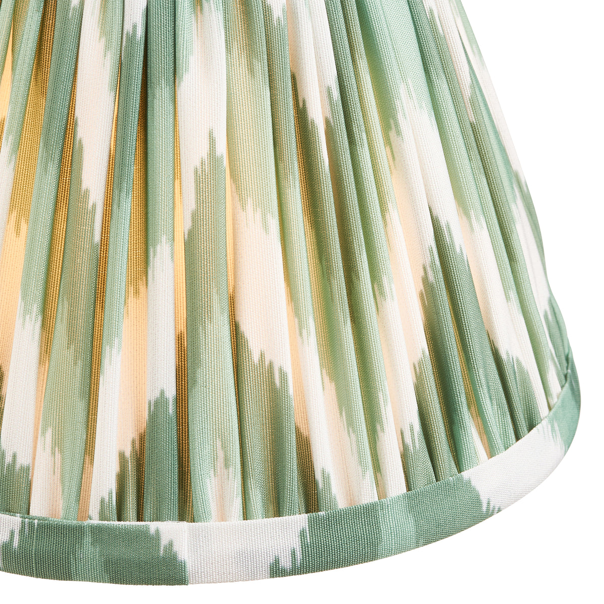 Close up of the Endon Dahlia Swan 16cm pleated shade lit, Cotswold green and white zigzag faux silk with taped edge