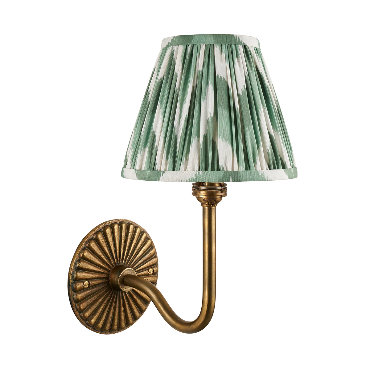 Endon Dahlia Swan antique brass wall light with green zigzag pleated shade, lit, full fitting on a plain white background