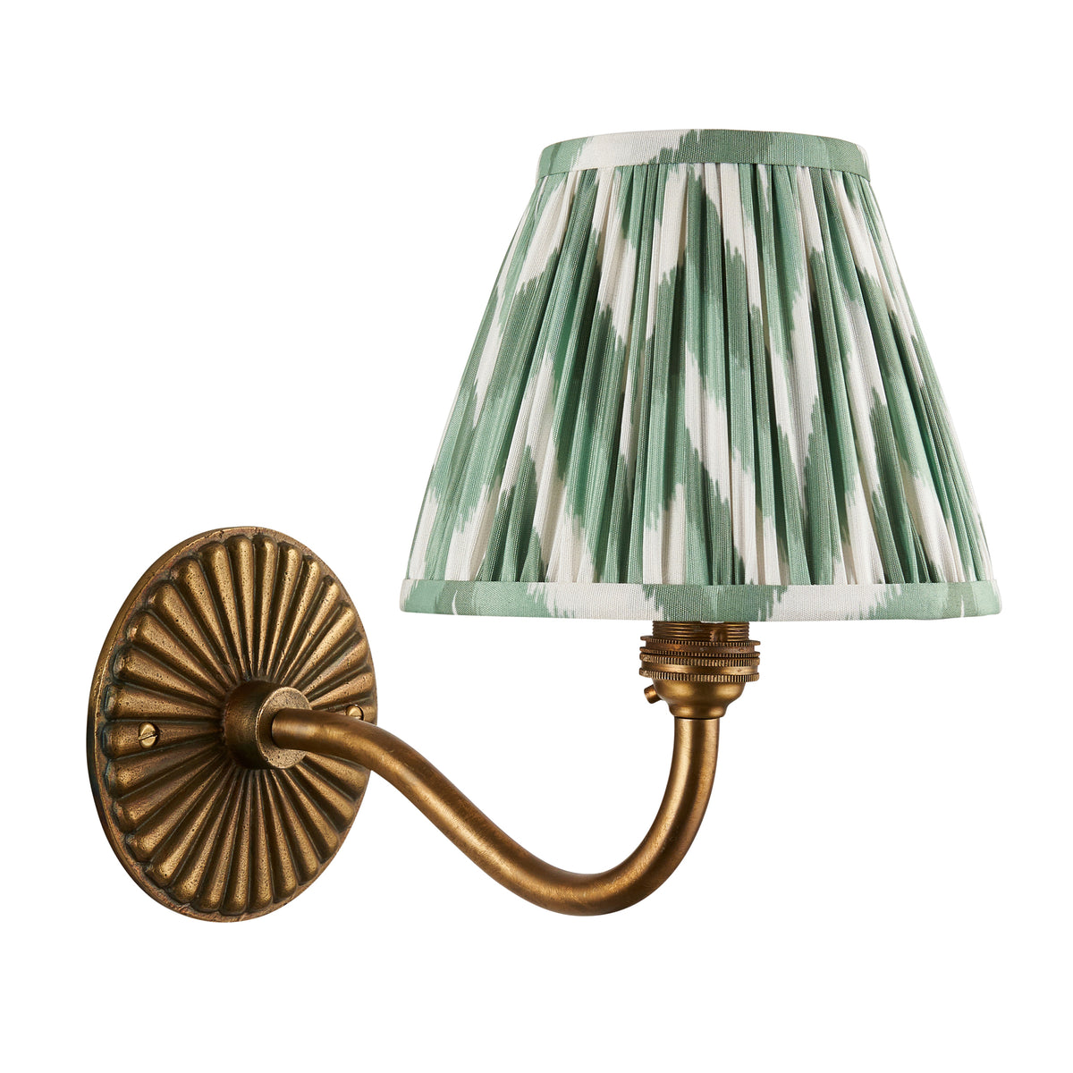 Endon Dahlia Curve wall light in antique brass with an unlit green zigzag pleated shade, cut out on a white background