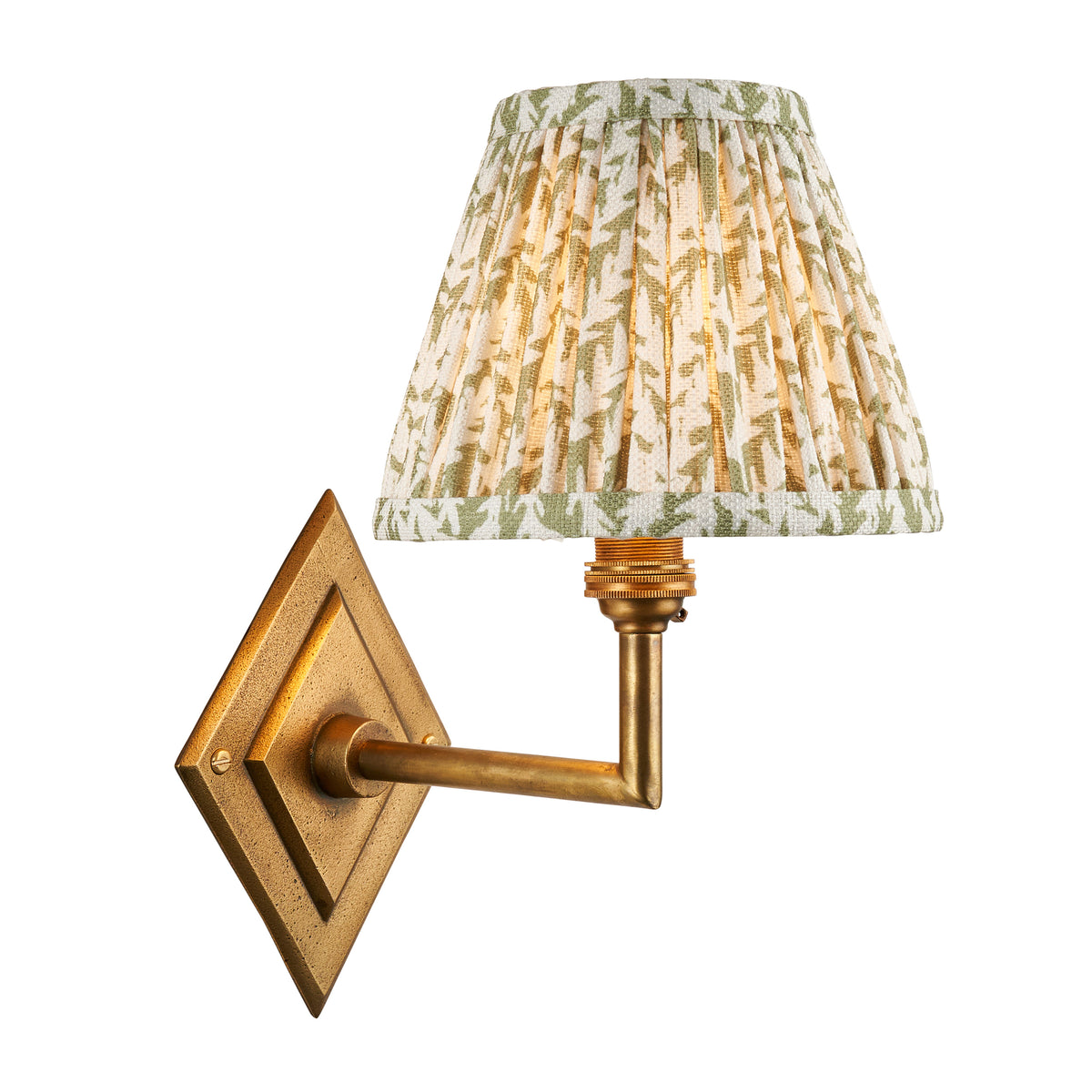Endon Diamond Angle wall light in antique brass with pleated green leaf print shade, lit, cut out on a white background