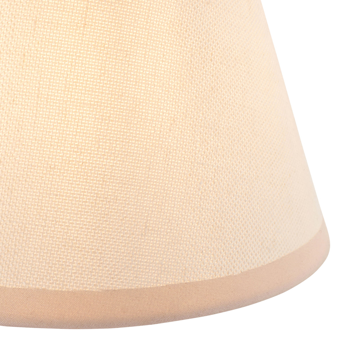 Close up of the lit vintage white cotton mix fabric on the Endon Ivy 16cm shade, with its almond white taped bottom edge