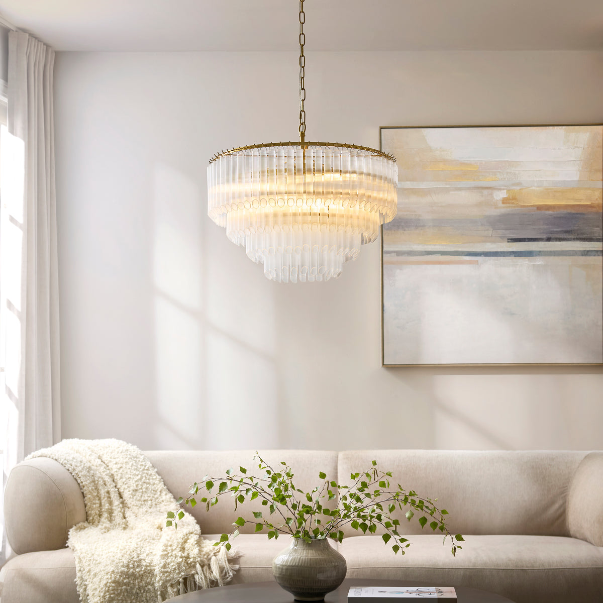 Studio shot of the Endon Montpellier 6 light pendant in brushed aged brass with clear ribbed glass rods cascading from the tiered frame