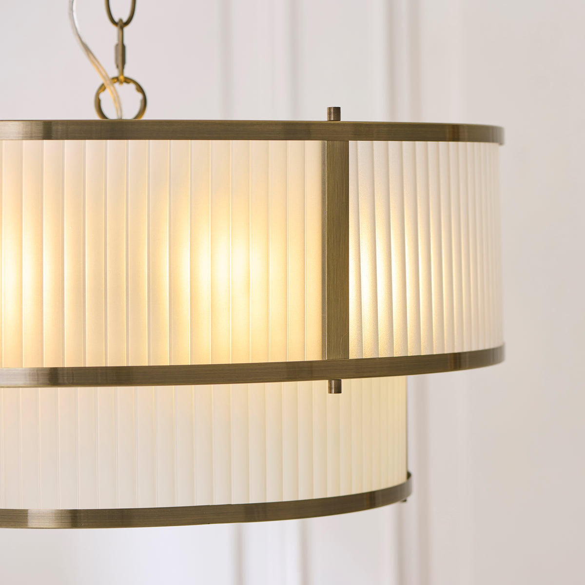 Close up detail of the antique brass spider frame and bulb holders inside the Endon Ridgeton 5 light tiered pendant
