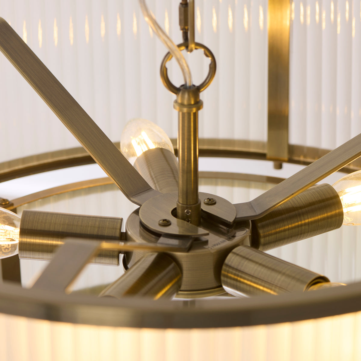 Close up detail of the antique brass frame connecting the two glass tiers on the Endon Ridgeton 5 light tiered pendant