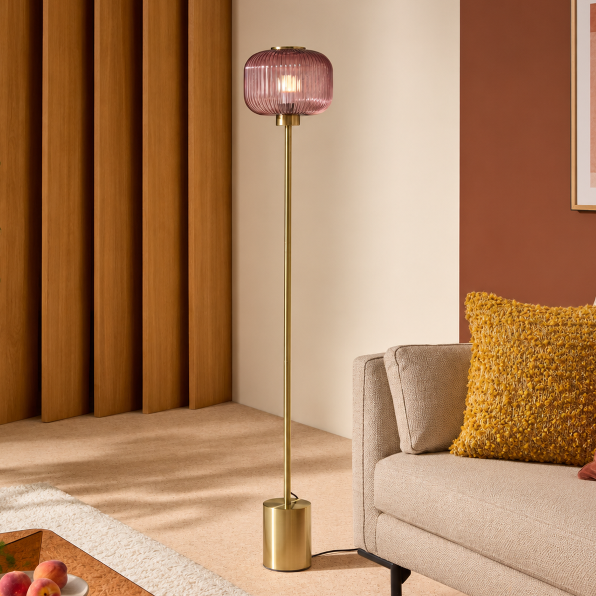 MADE.COM Briz floor lamp in brushed brass with ribbed pink glass shade, living room shot beside a sofa