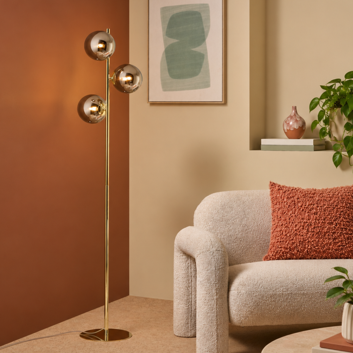 MADE.COM Globe floor lamp in polished brass with smoke grey lustre glass globes, lifestyle shot beside an armchair
