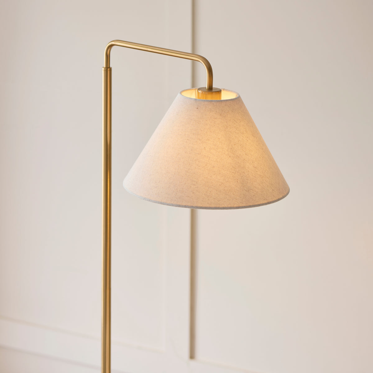 Close up shot of the scalloped bottom edge of the Endon Wallbridge floor light shade glowing from the light inside