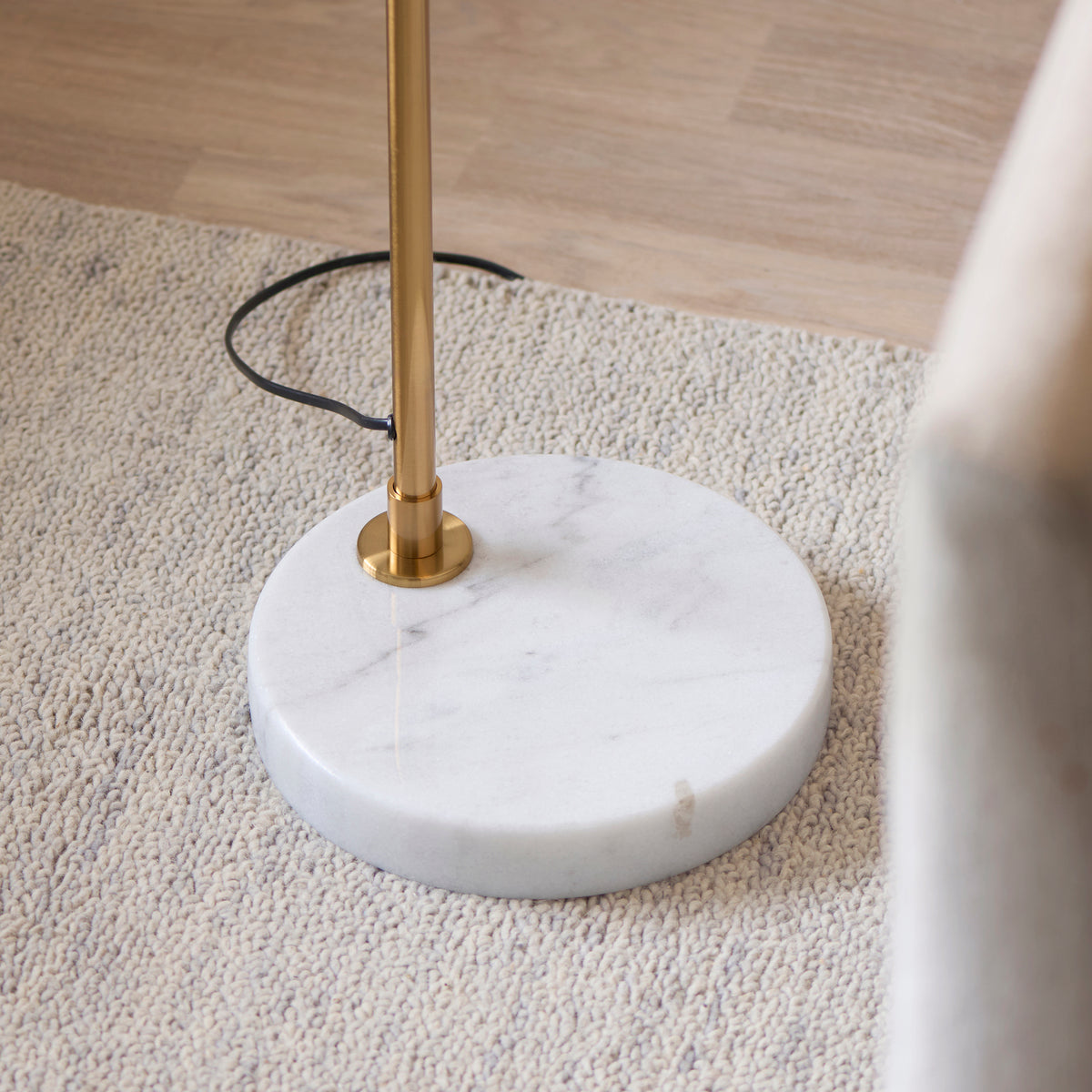 Endon Wallbridge floor light in brushed aged brass with a white marble base shown as a plain product shot on a white background, unlit