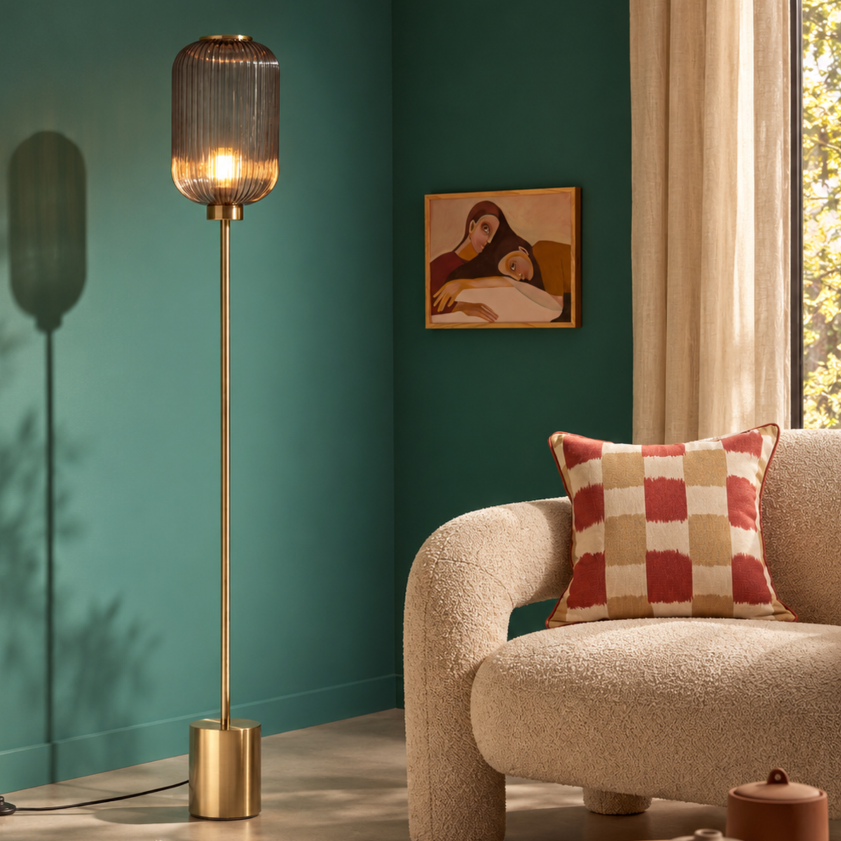 MADE.COM Briz floor lamp in brushed brass with tall ribbed grey glass shade, lifestyle shot on a teal wall