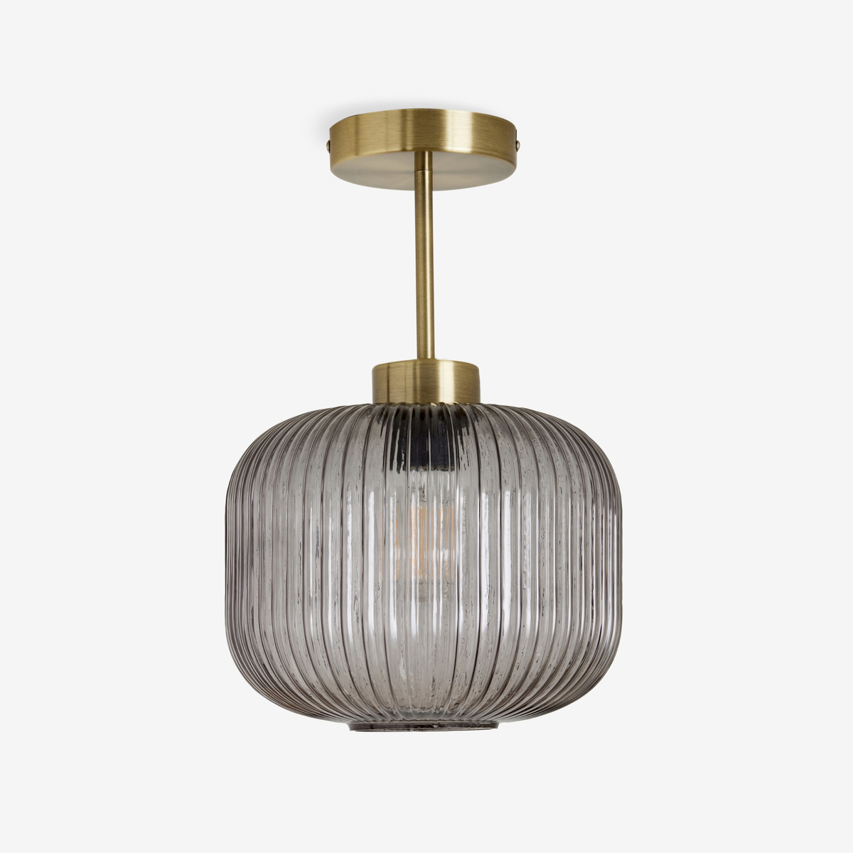 MADE Briz flush ceiling light in antique brass with ribbed grey glass shade, studio shot unlit
