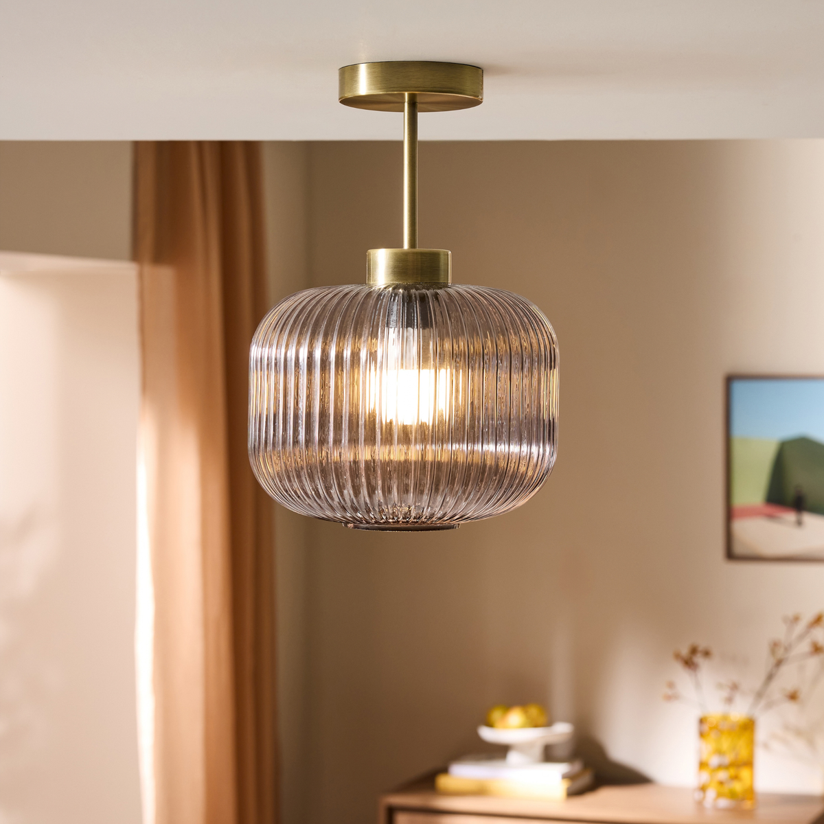 MADE Briz flush ceiling light in antique brass with ribbed grey glass shade, lifestyle shot in a room