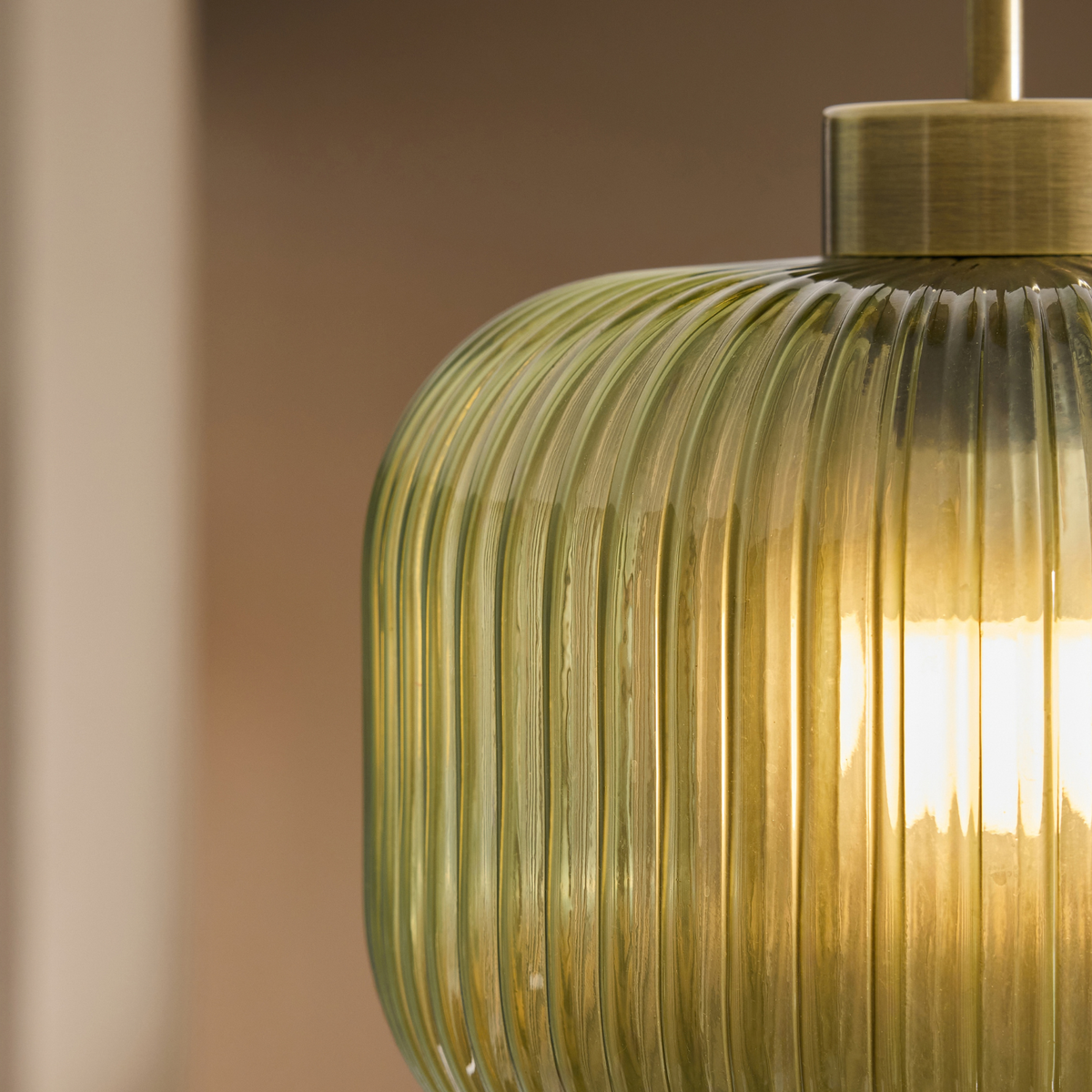 MADE.COM Briz flush ceiling light close up of ribbed green glass shade and antique brass collar