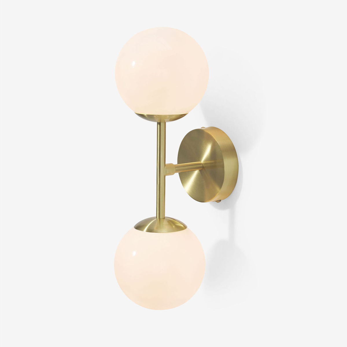 MADE.COM Globe wall light in brushed brass with two opal glass globes, studio shot