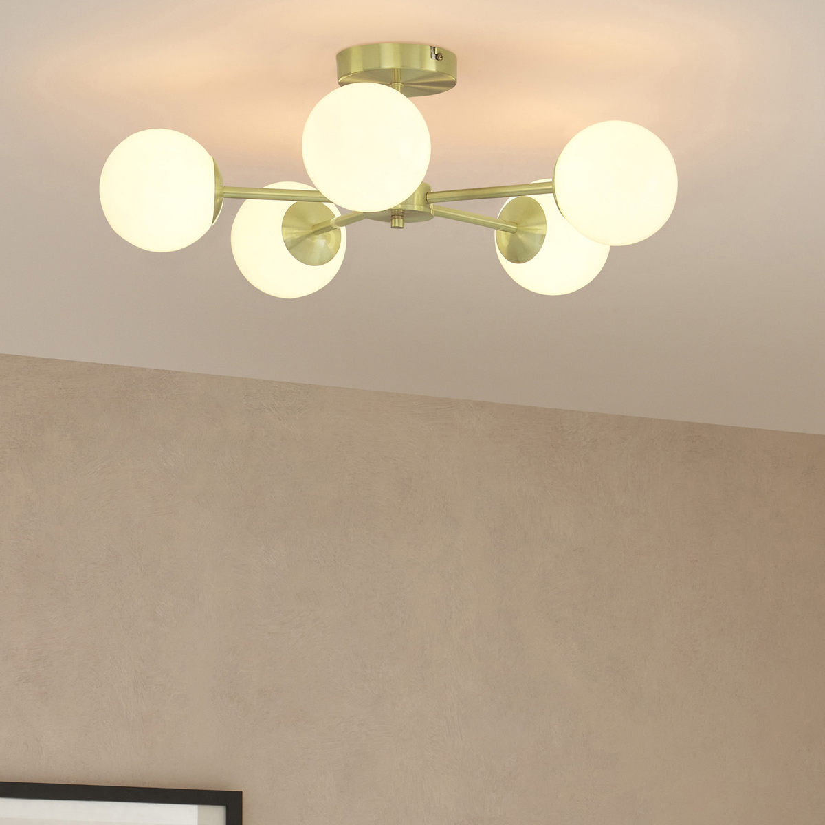 MADE.COM Globe 5 light flush ceiling light in brushed brass with opal glass globes in a room