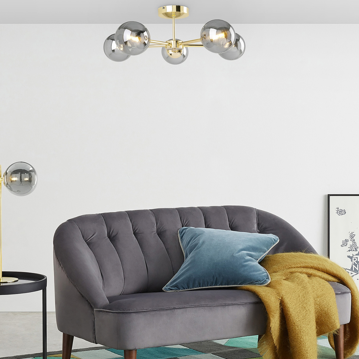 MADE Globe 5 light ceiling light with smoked glass globes above a grey velvet sofa, wide room shot