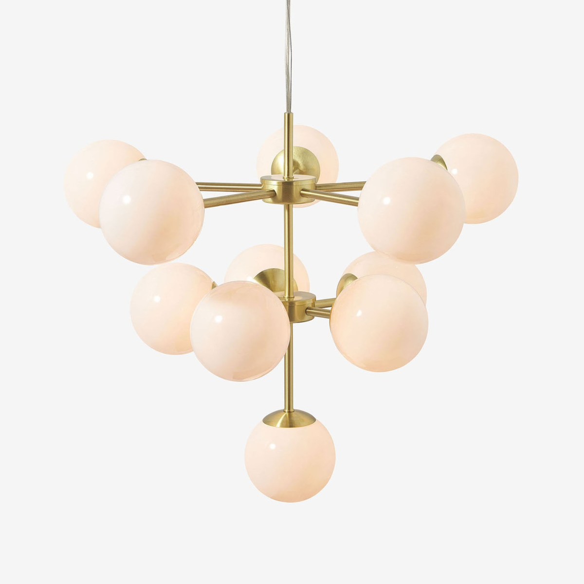 MADE Globe chandelier in brushed brass with opal glass globes, studio shot on grey