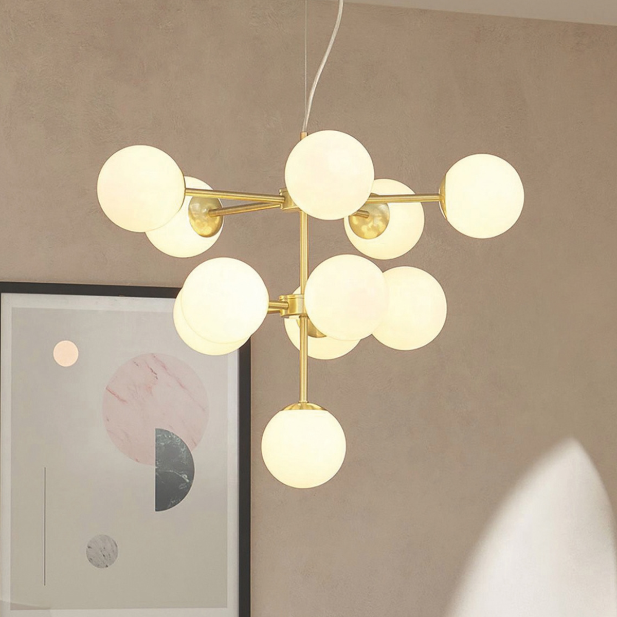 Close view of MADE.COM Globe chandelier with clustered opal glass globes on brushed brass arms