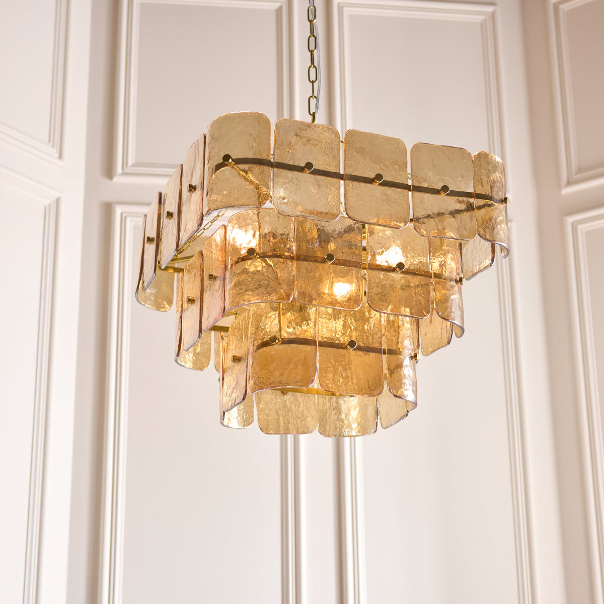 Endon Venice 10 light pendant in brushed aged brass with champagne handmade textured glass shown lit as a plain product shot on white