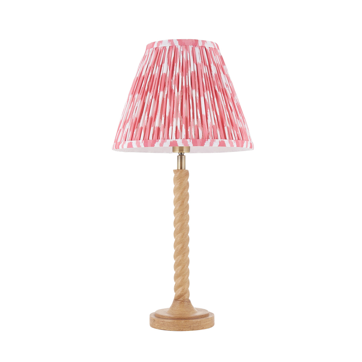 Endon Twist table lamp in oak effect resin with a 25cm coral pink ikat shade, unlit, cut out on a white background