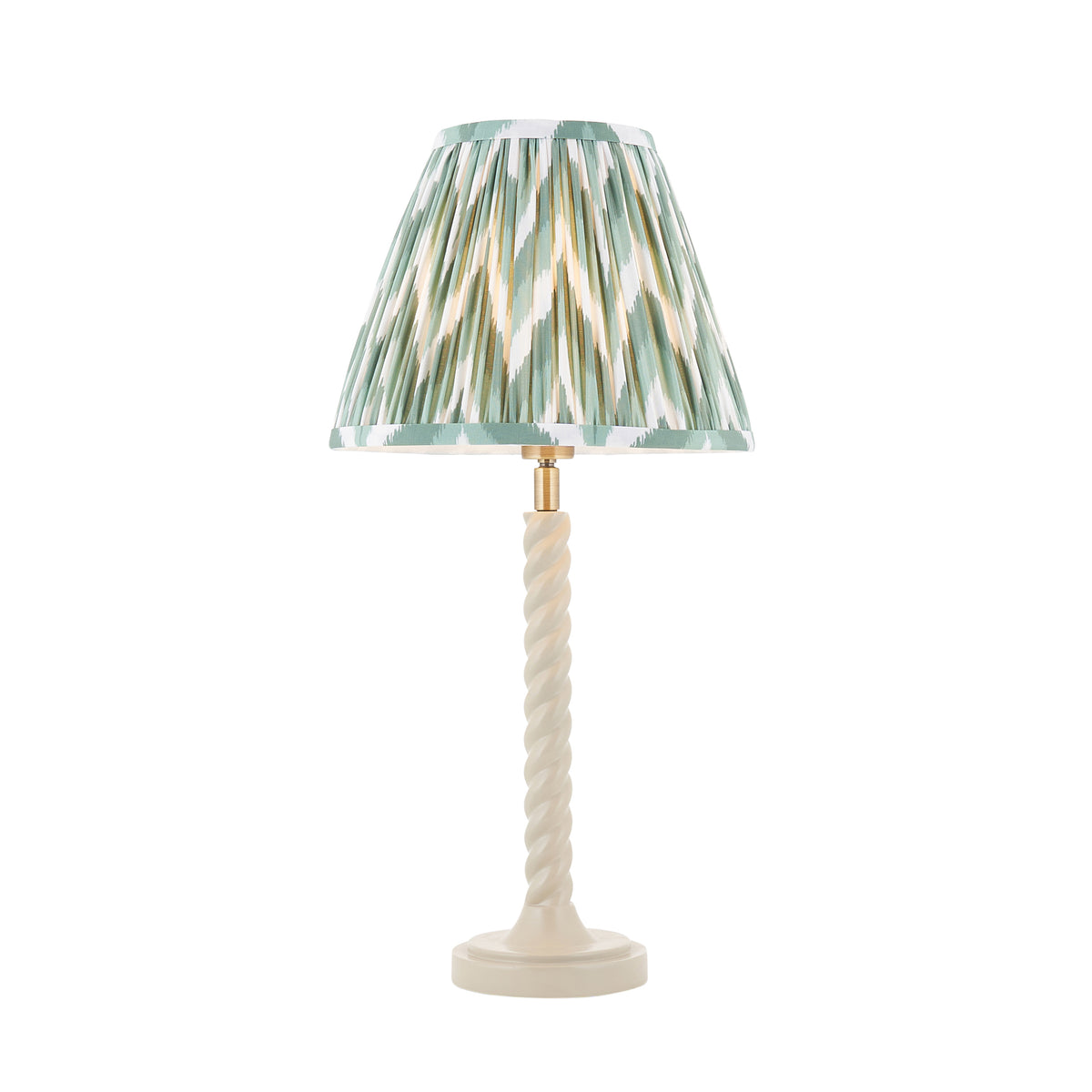 Endon Twist table lamp lit, satin almond white twisted stem with a green and white zigzag pleated shade, cut out on white