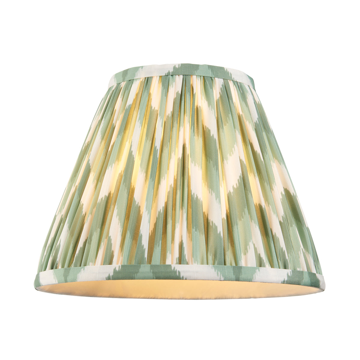 Endon Zigzag 25cm Cotswold green pleated faux silk lamp shade on its own, lit, showing the green, white and olive zigzag print