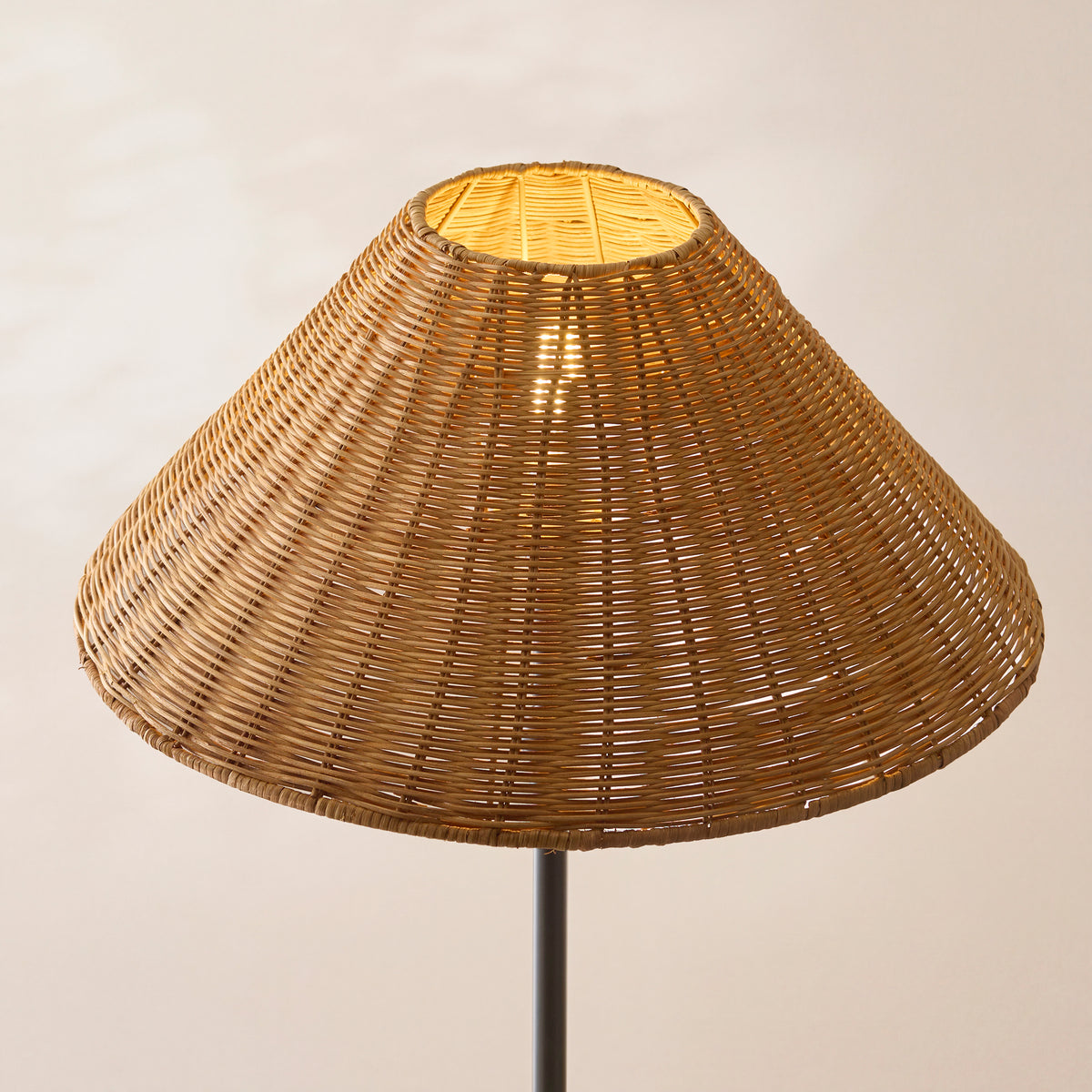 Close up of the Endon 52cm dark rattan shade from slightly below, lit, showing the hand woven weave and open top