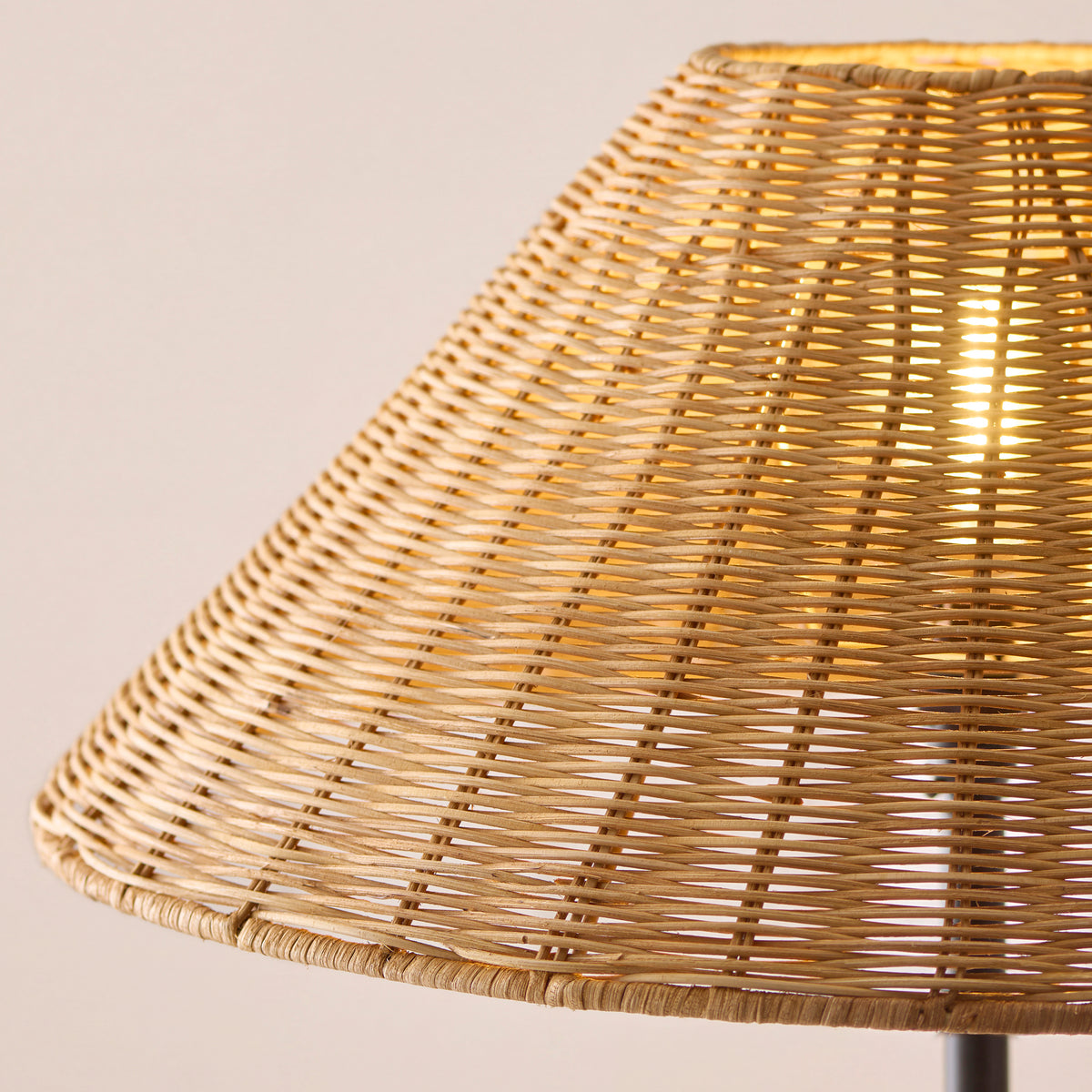 Detail of the Endon dark rattan shade lit from inside, showing light coming through the woven rattan strands