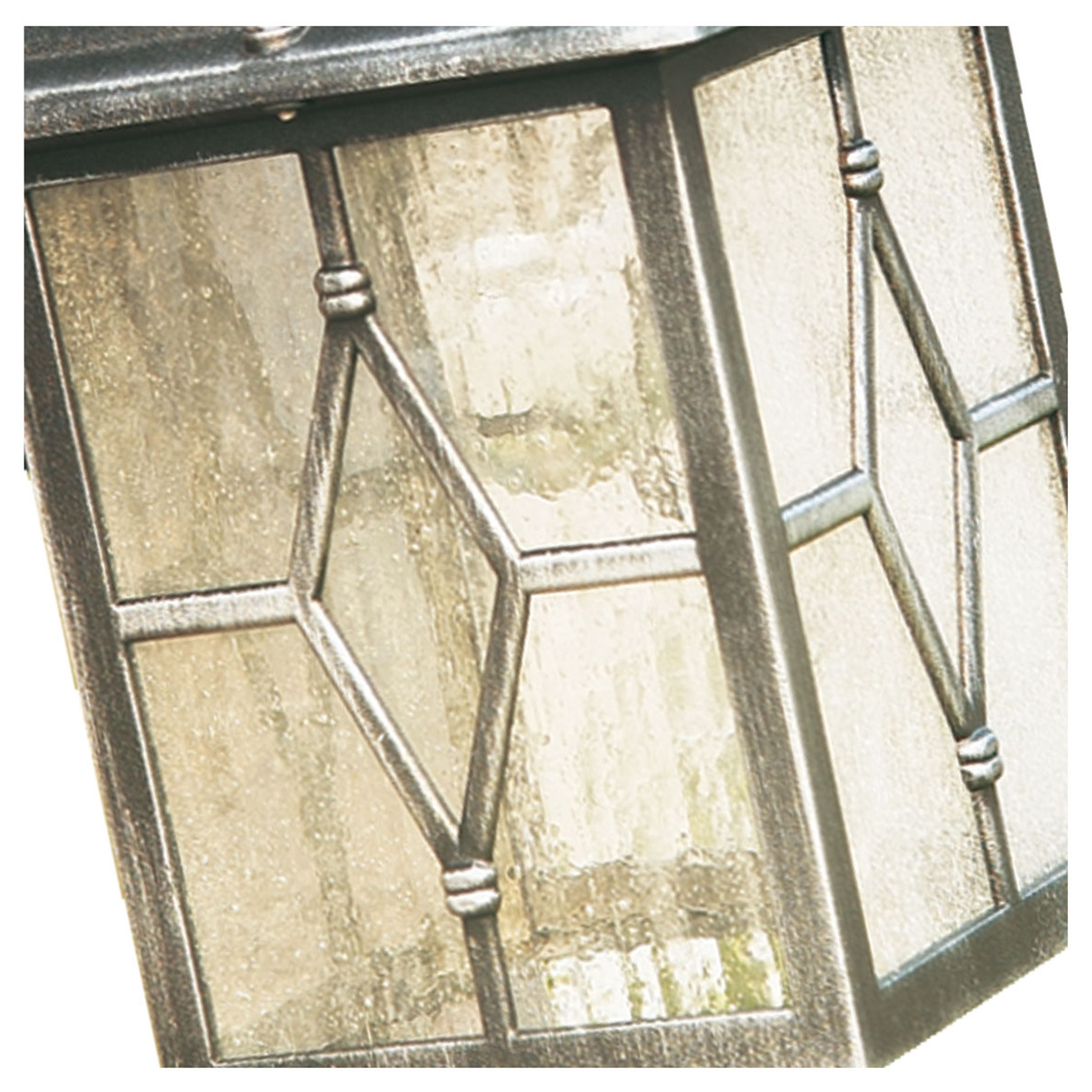 Close up of the Genoa outdoor wall light's diamond leaded glass panel and cast metal frame detail
