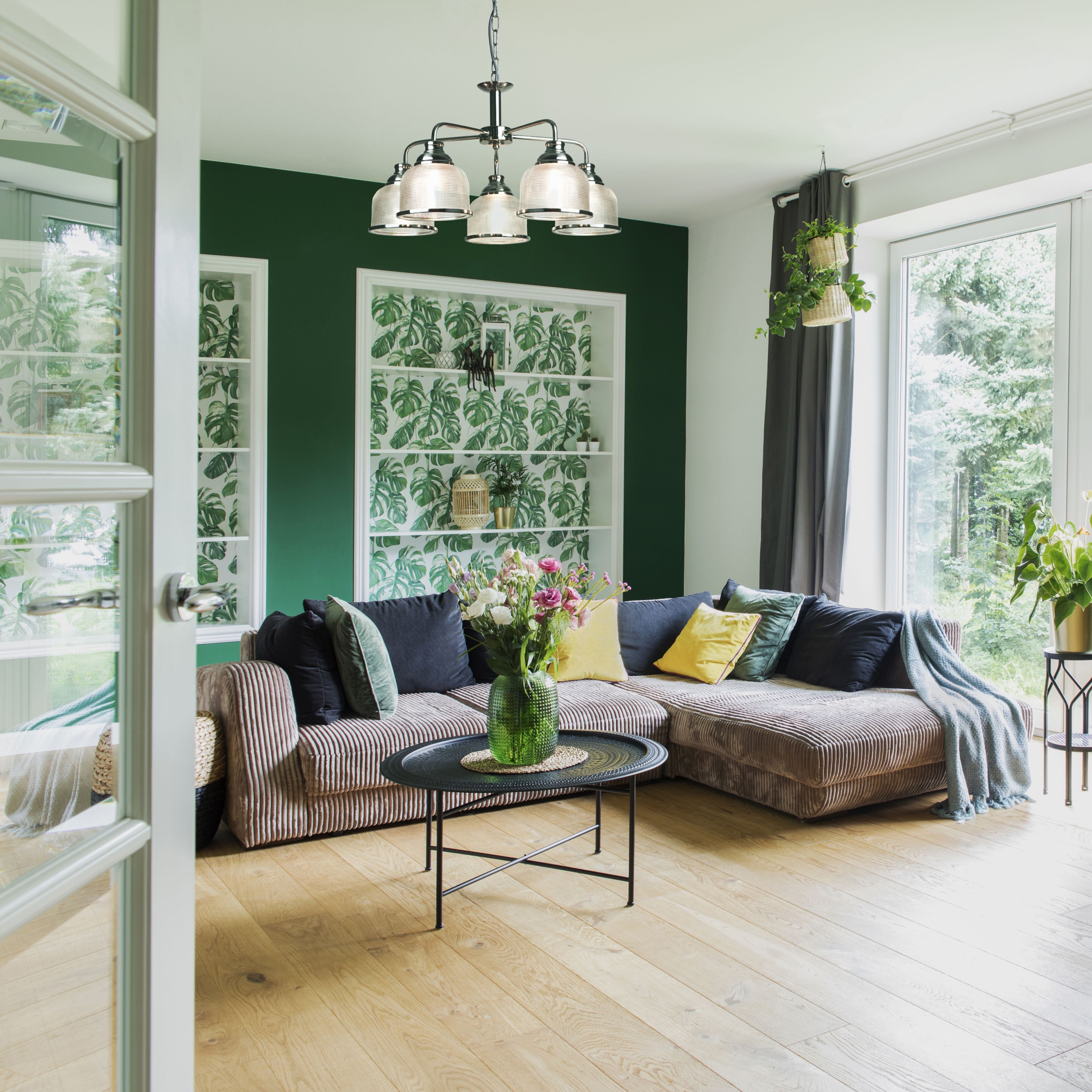 Searchlight Bistro II 5 Light Pendant in satin silver styled above a striped sofa in a green painted living room with botanical shelving
