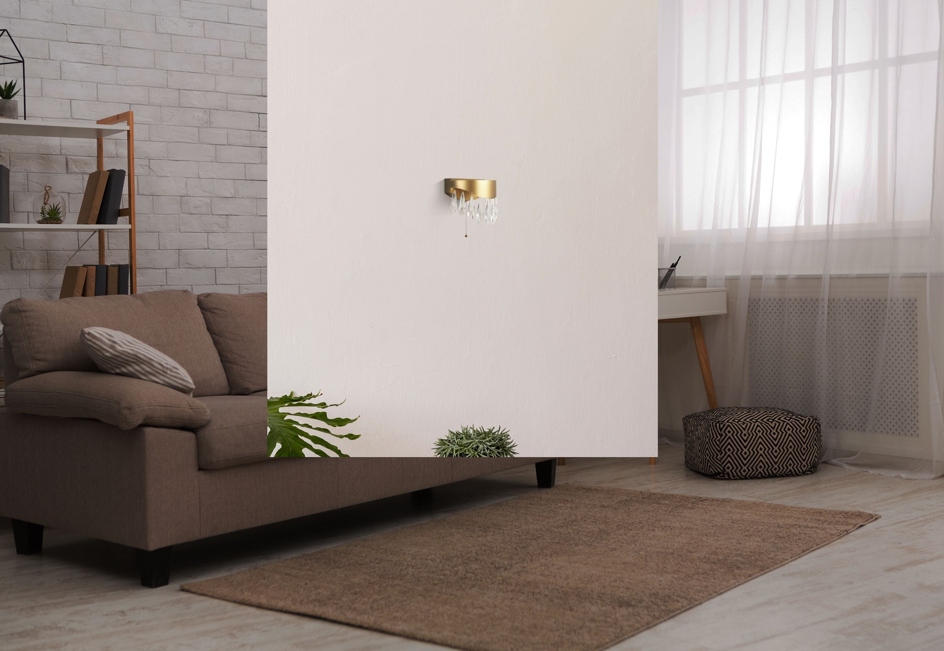 Jewel wall light in gold mounted on a wall above a sofa in a living room setting