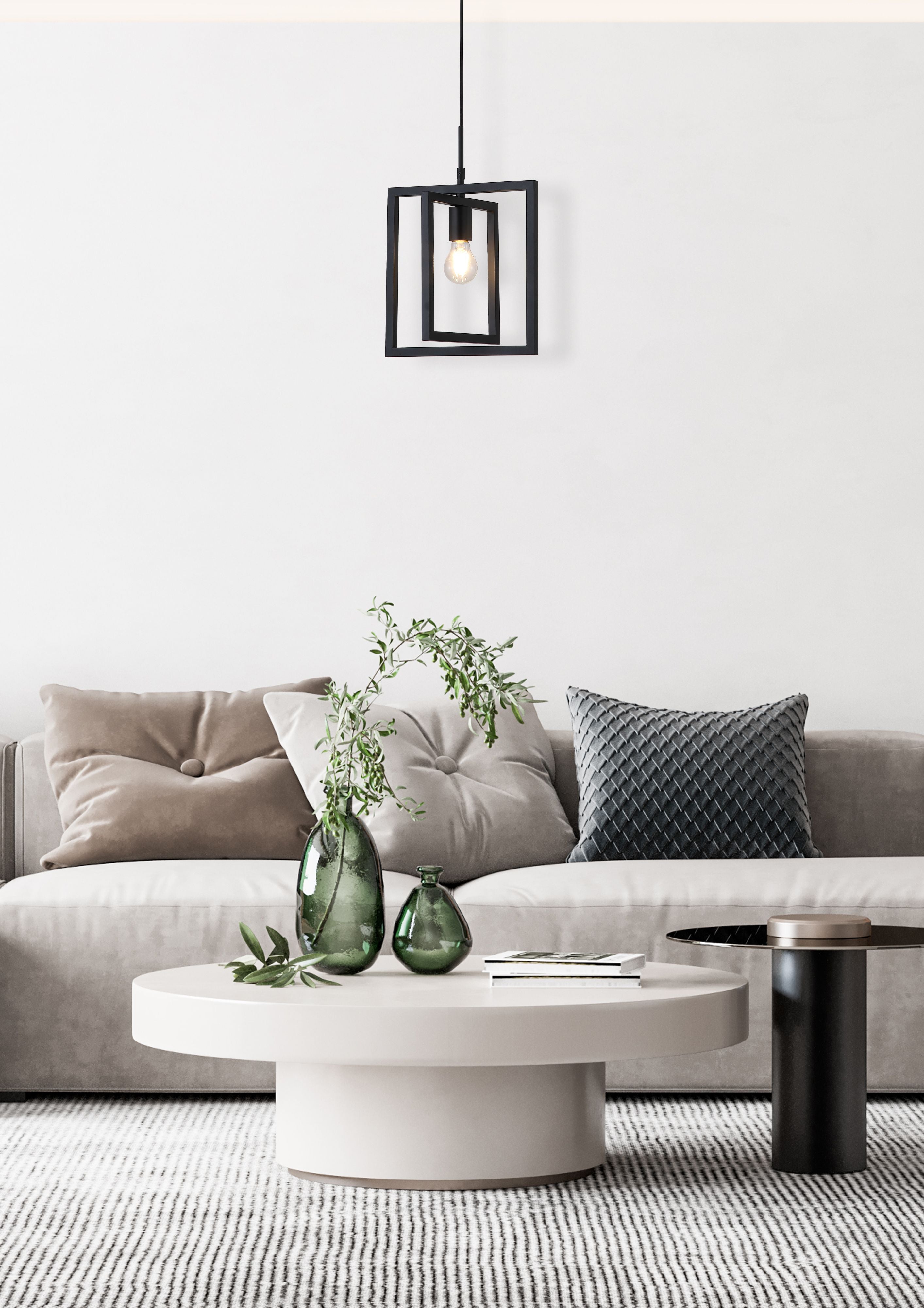 Searchlight Plaza 1 Light Pendant in matte black styled above a coffee table in a bright neutral living room with a grey sofa and cushions