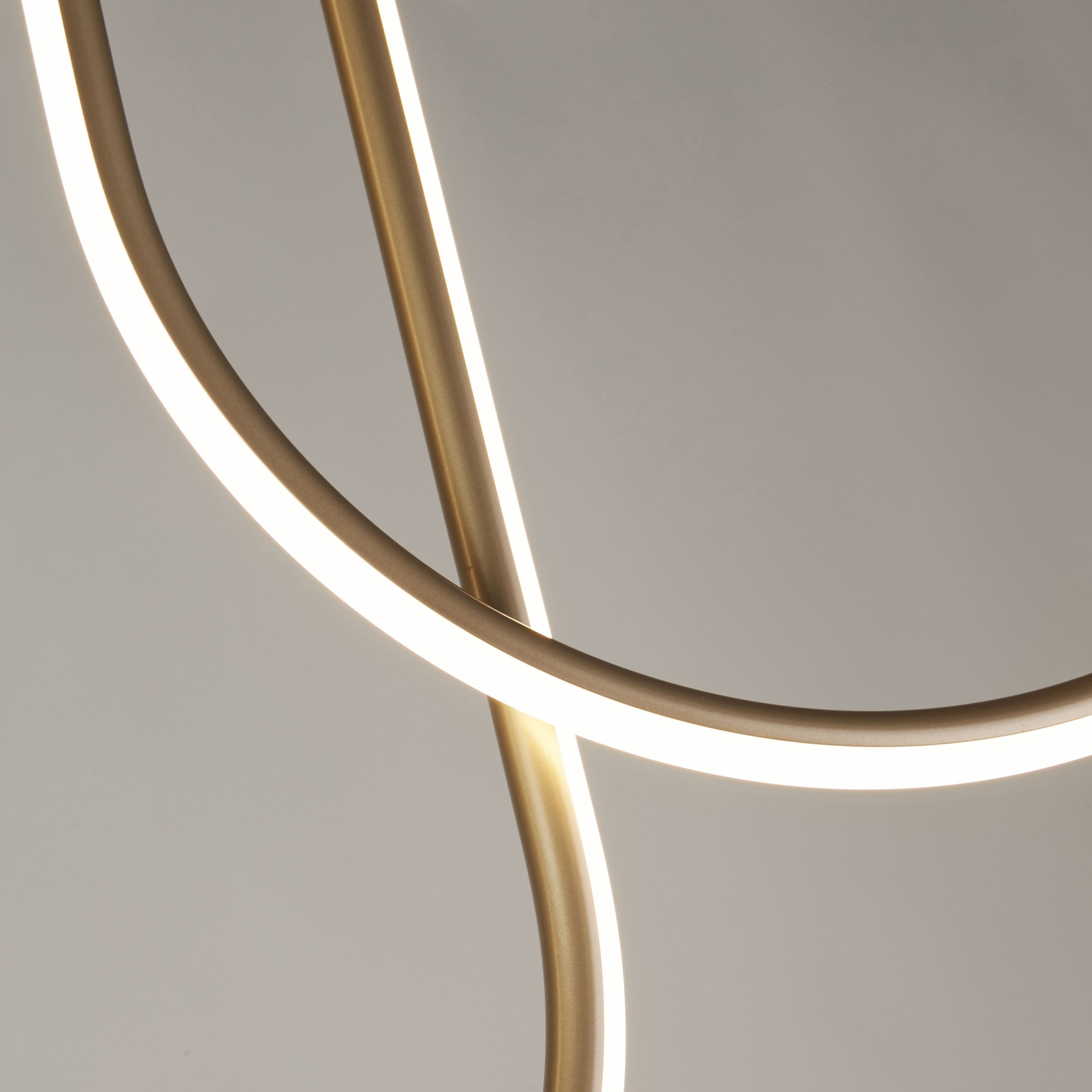 Close up of two crossing curved arms on the Searchlight Chime LED Flush in bronze effect metal, showing the integrated LED strip lit