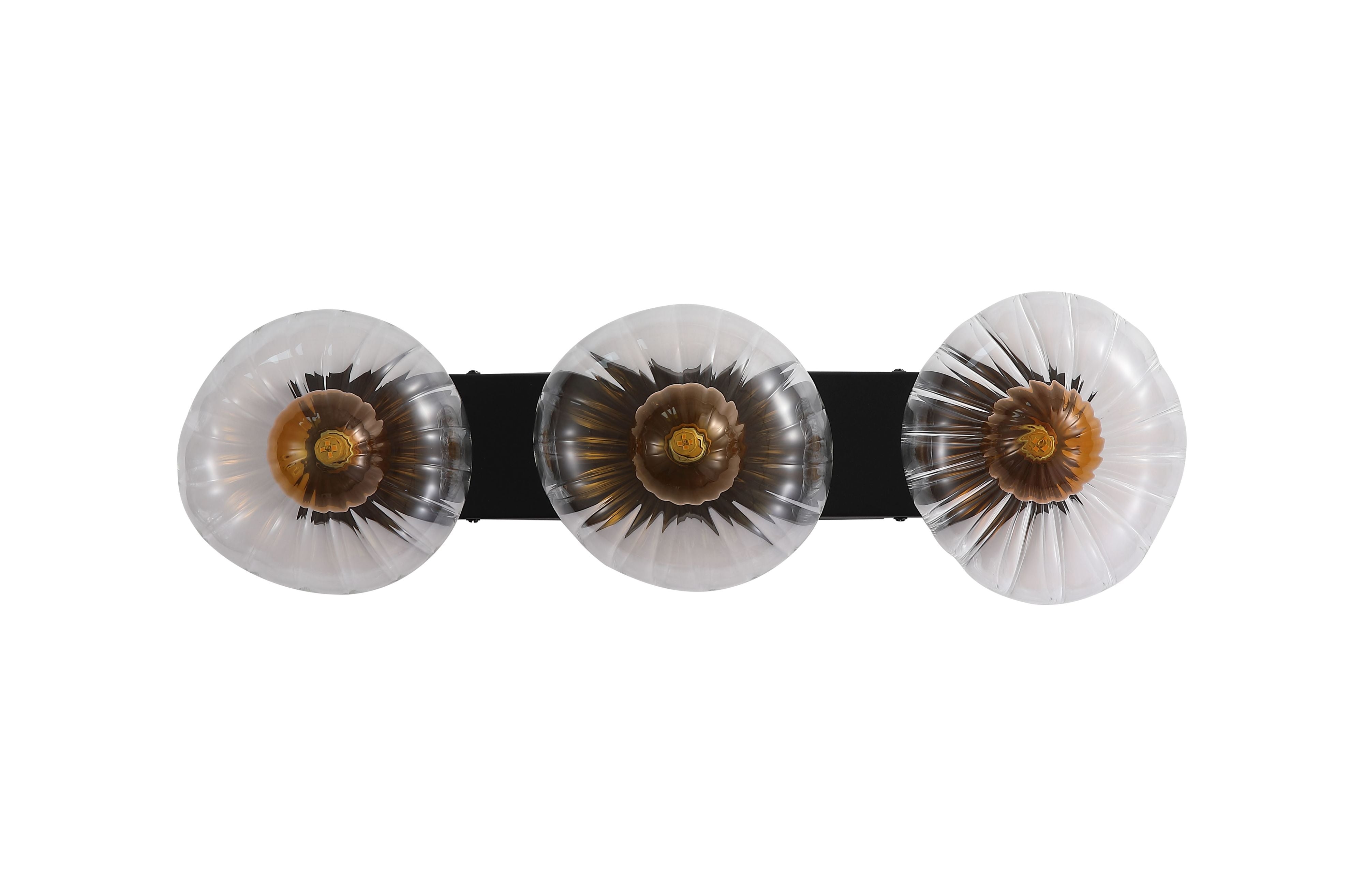 Searchlight Sunbeam 3 light wall light, straight on view showing deeper amber and bronze tones in the fluted glass discs when lit
