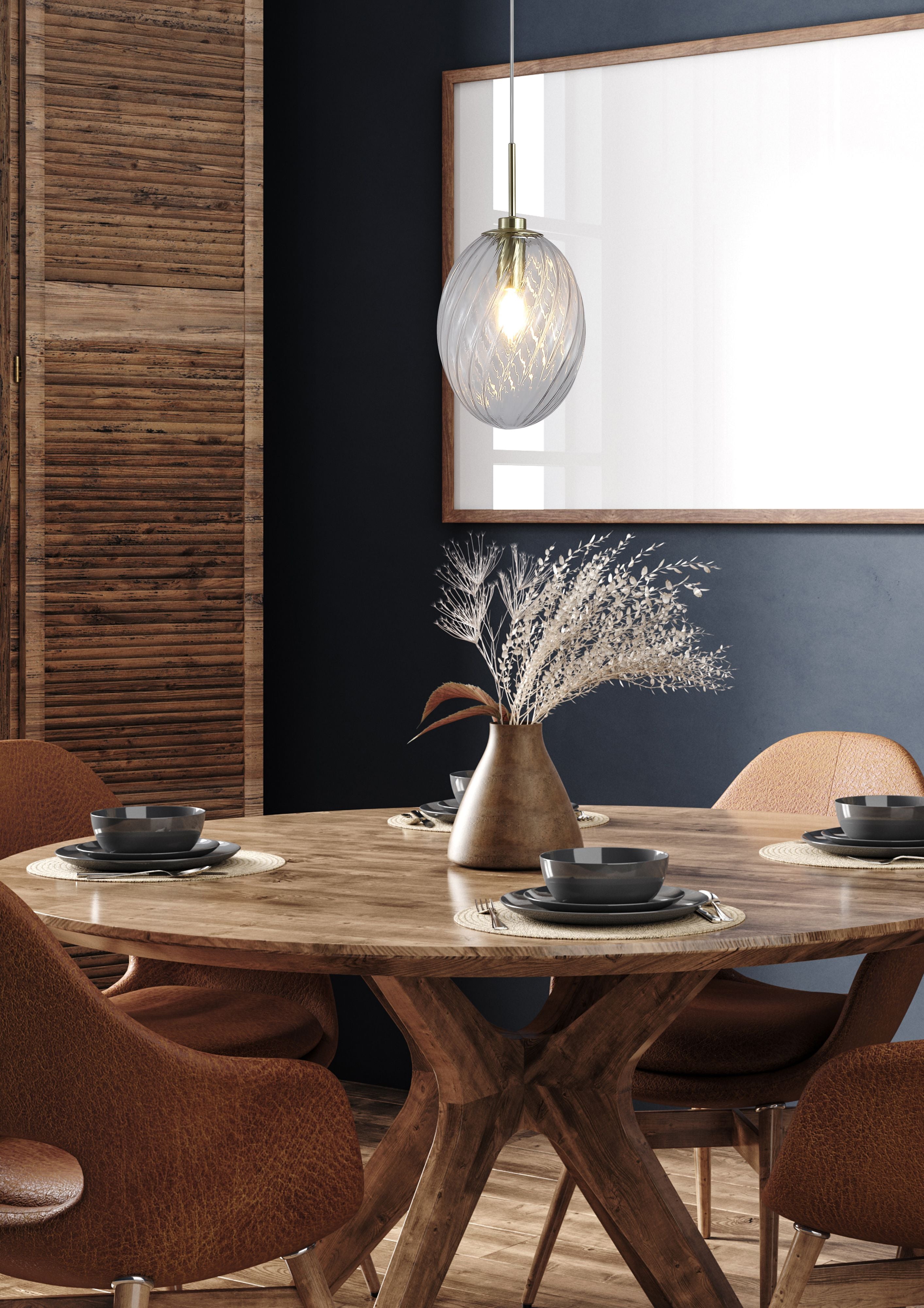 Whirl 1 Light Pendant styled above a round wood dining table set with dark bowls in a room with dark blue walls