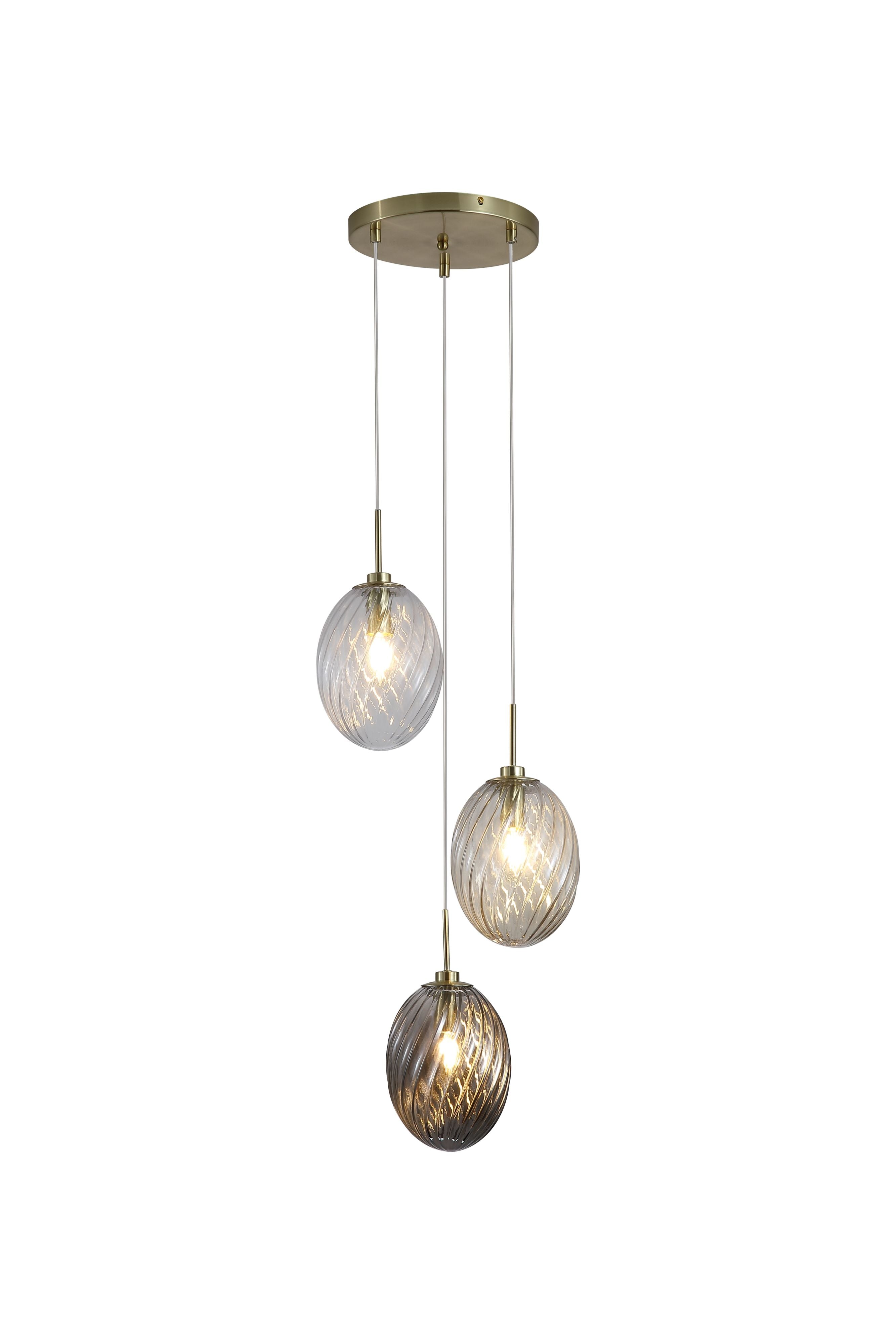 Searchlight Whirl 3 light multi drop pendant with a round satin brass ceiling plate suspending three staggered oval swirled glass shades in clear, champagne and smoked tones, against a plain white background