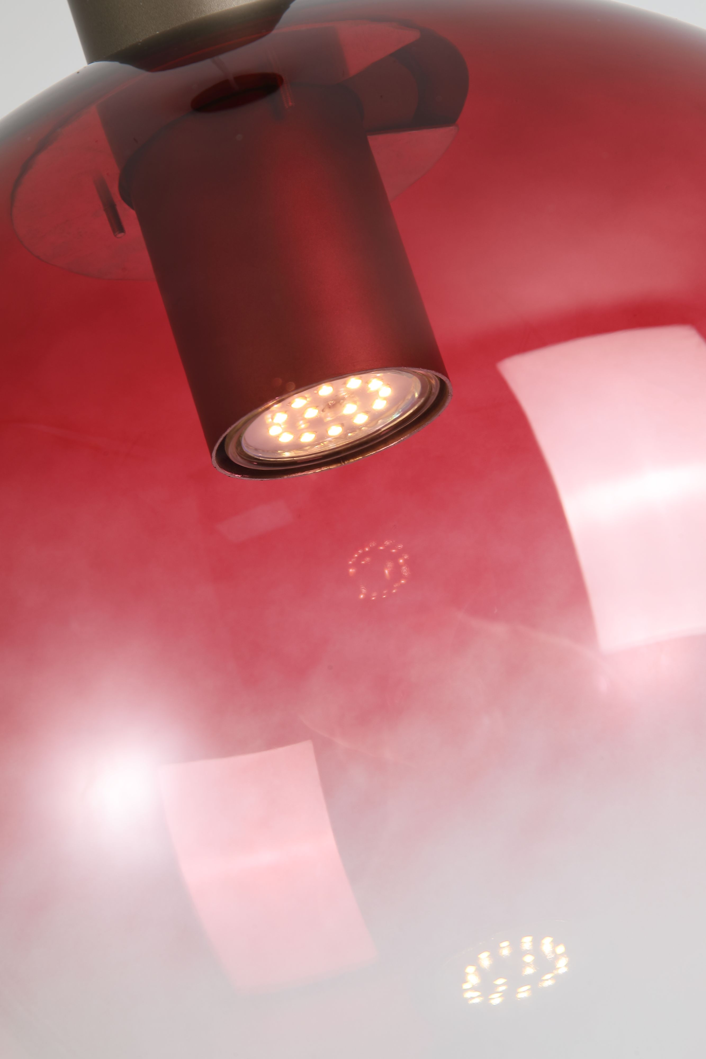 Close up of the GU10 spotlight inside the ruby red ombre glass globe, showing the fade to clear glass