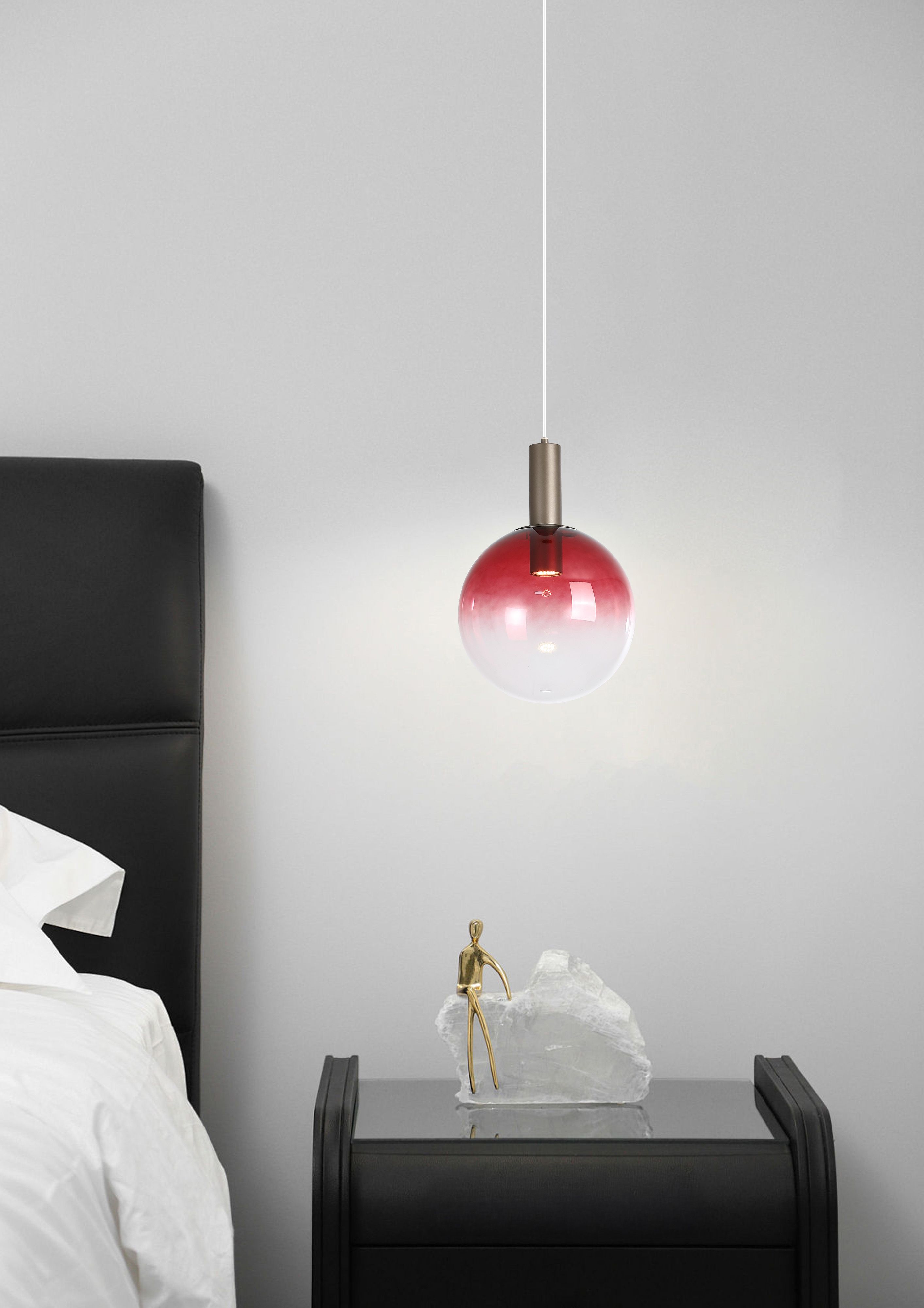 Ruby red ombre glass Ombre pendant hanging beside a bed with a dark headboard and crystal ornament on the nightstand