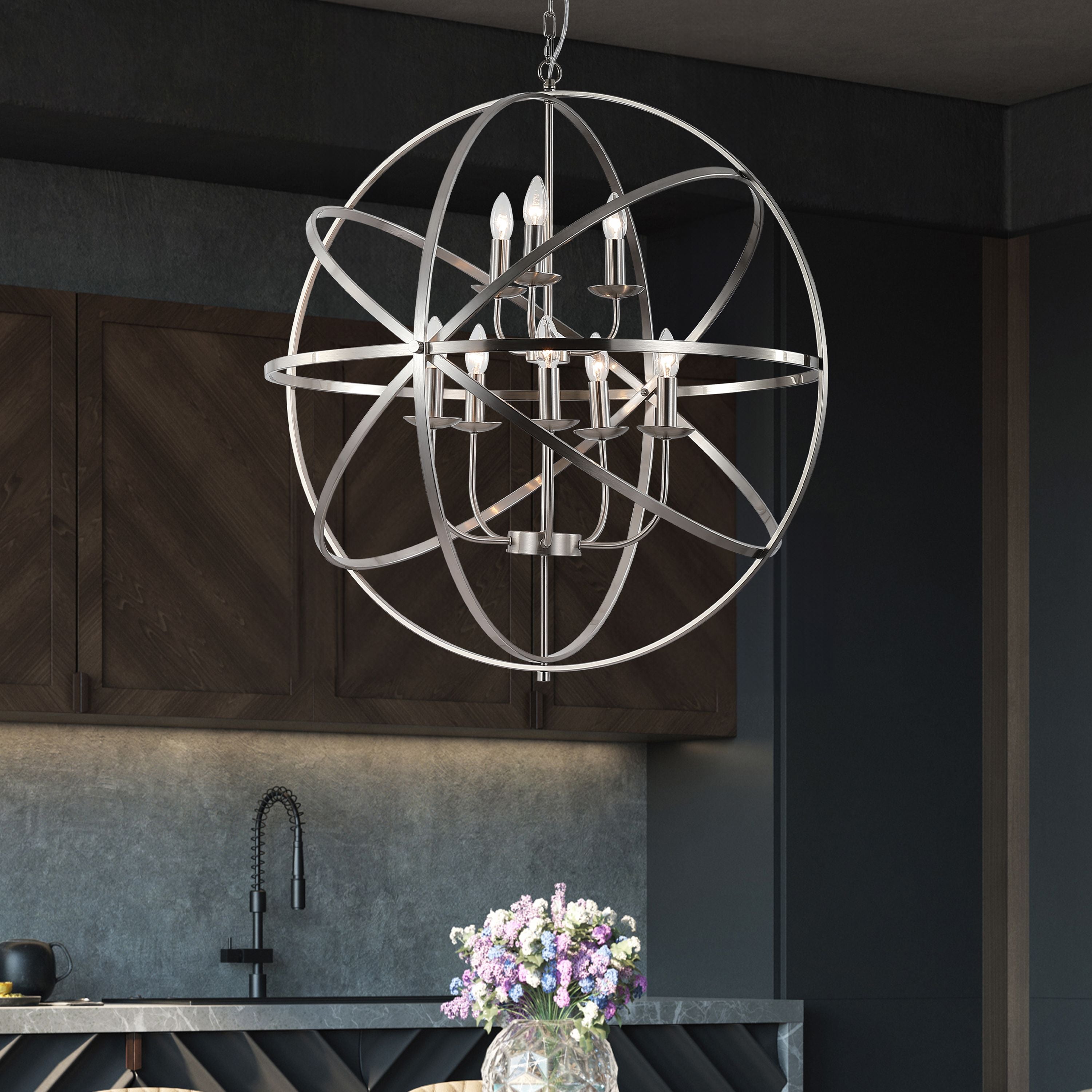 Searchlight Orbit 8 Light Pendant in satin silver styled above a kitchen island in a dark modern kitchen with a vase of flowers below