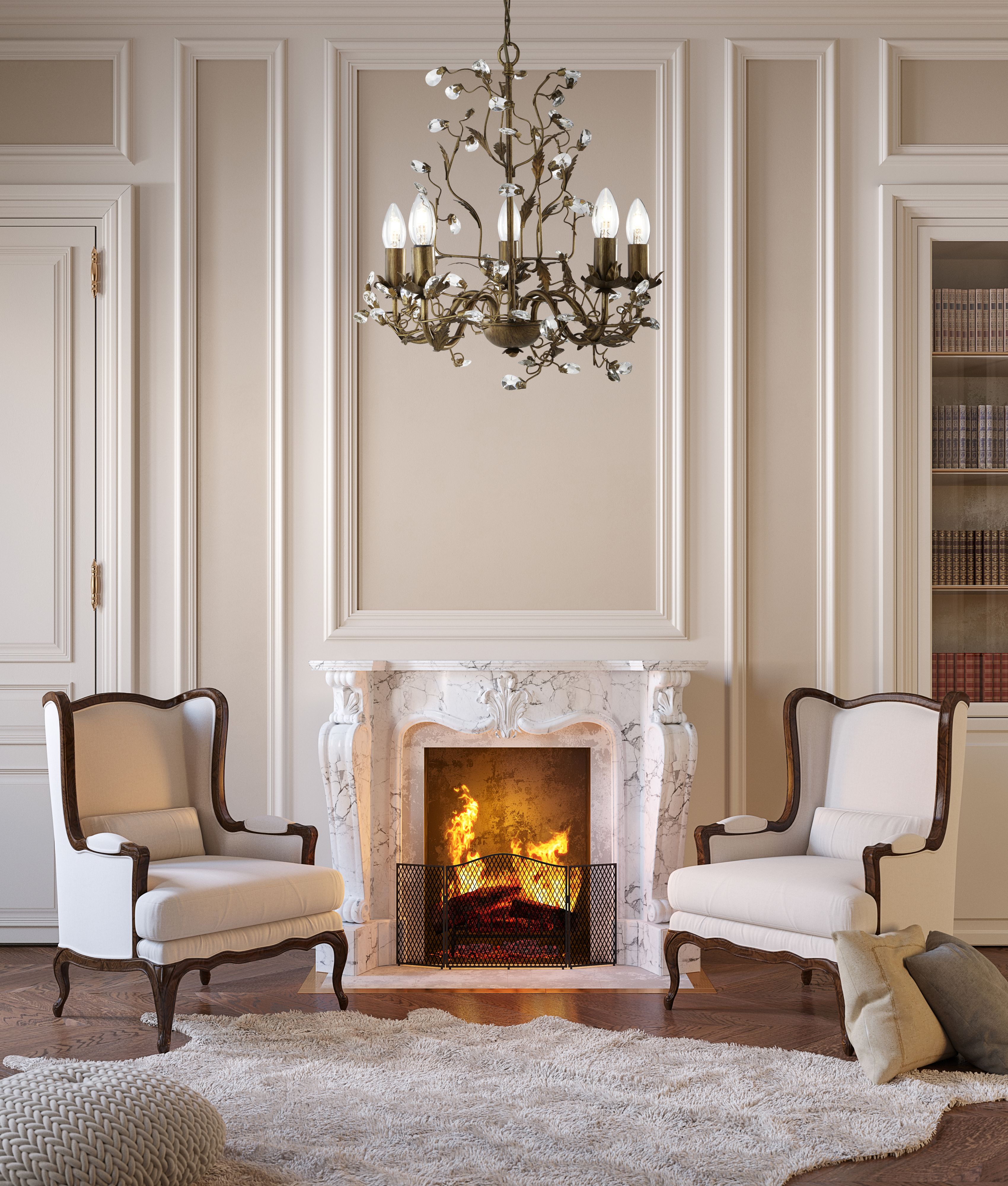 Almandite pendant lit and hanging above a marble fireplace in a cream panelled living room with wing back chairs