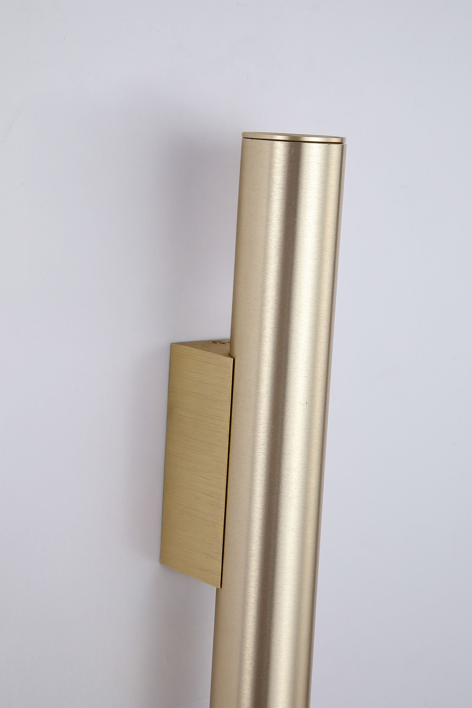 Close up of the Beacon wall light in brushed gold showing the wall mounting bracket and top cap detail