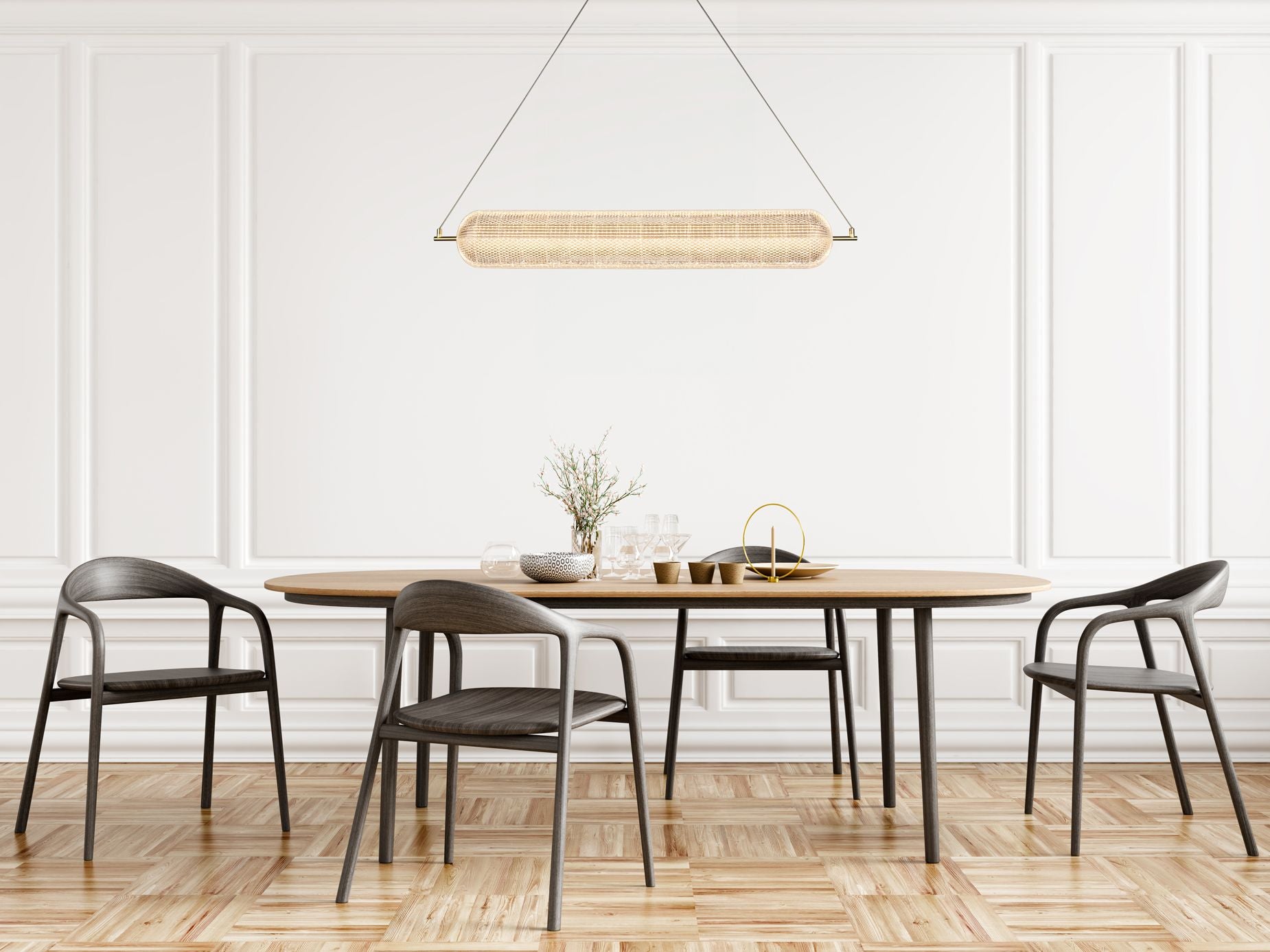 Searchlight Capsule LED convertible pendant in satin brass, hung above a white oval dining table styled with glassware, lit warm white