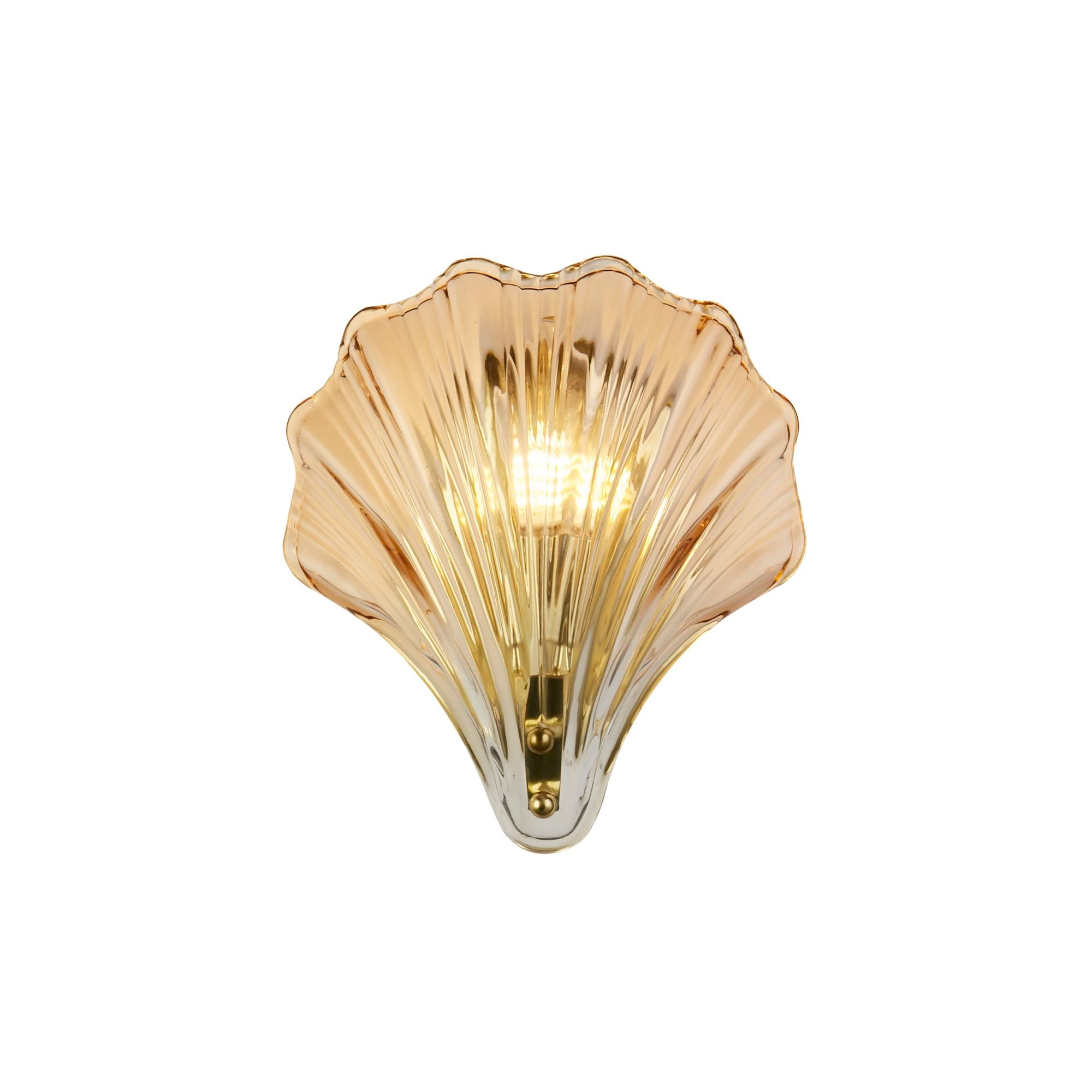 Searchlight Shell wall light with amber ombre glass shade in a scallop shell shape, satin brass fitting, studio shot, illuminated