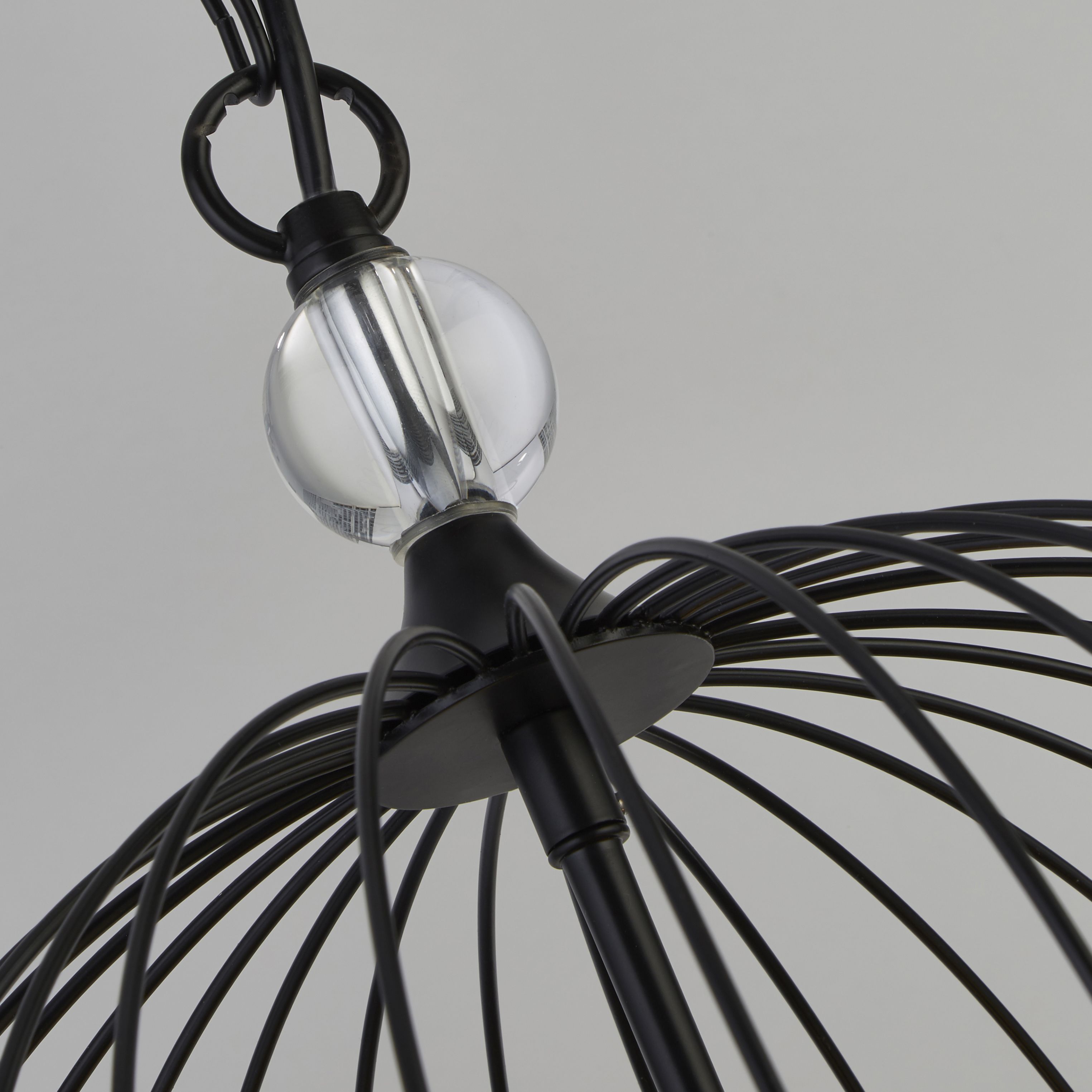 Close up of the crystal ball finial and matt black frame joint on the Shower pendant