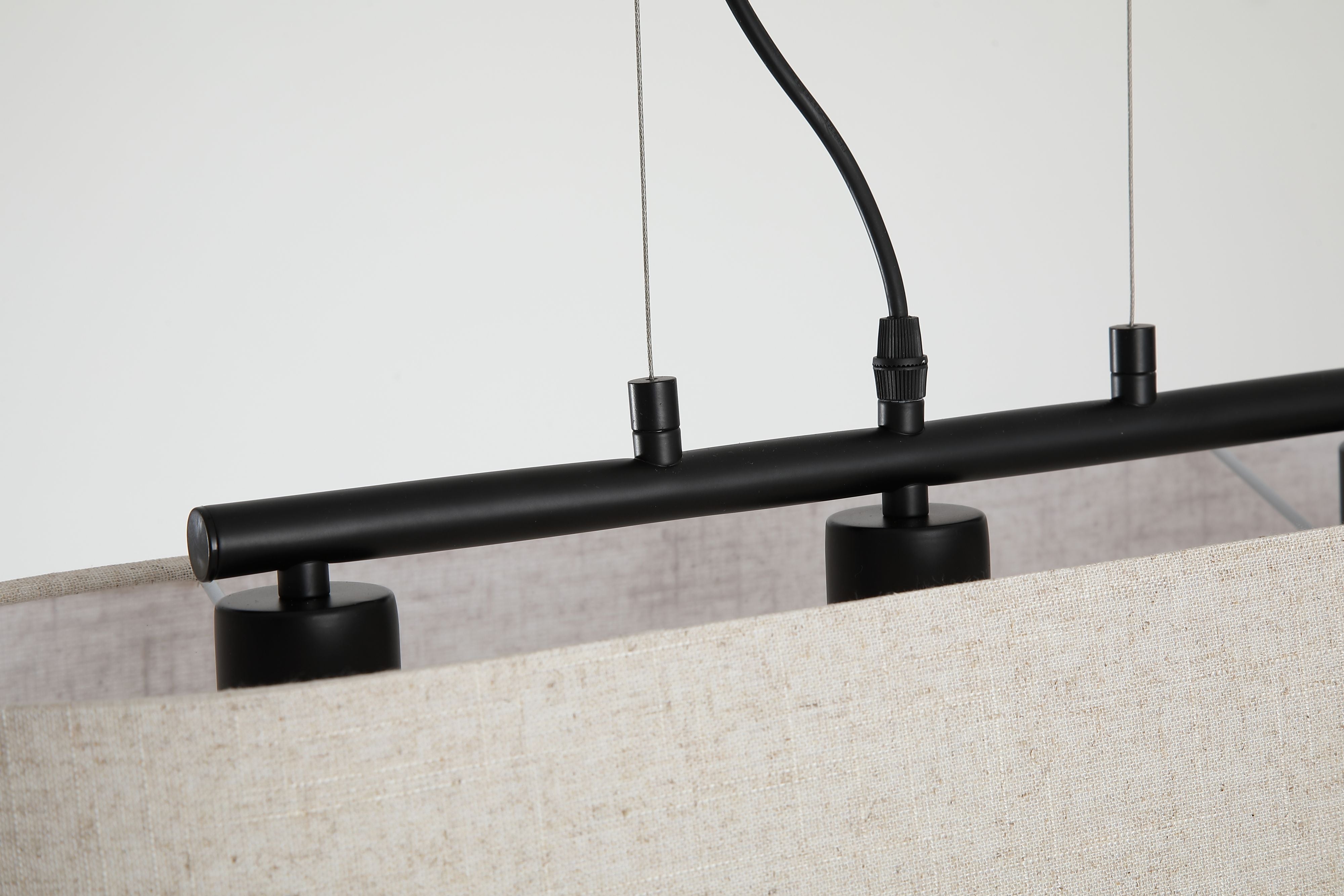 Close up of the Searchlight Hessian pendant's black ceiling plate and three E27 bulb holders sitting above the linen shade