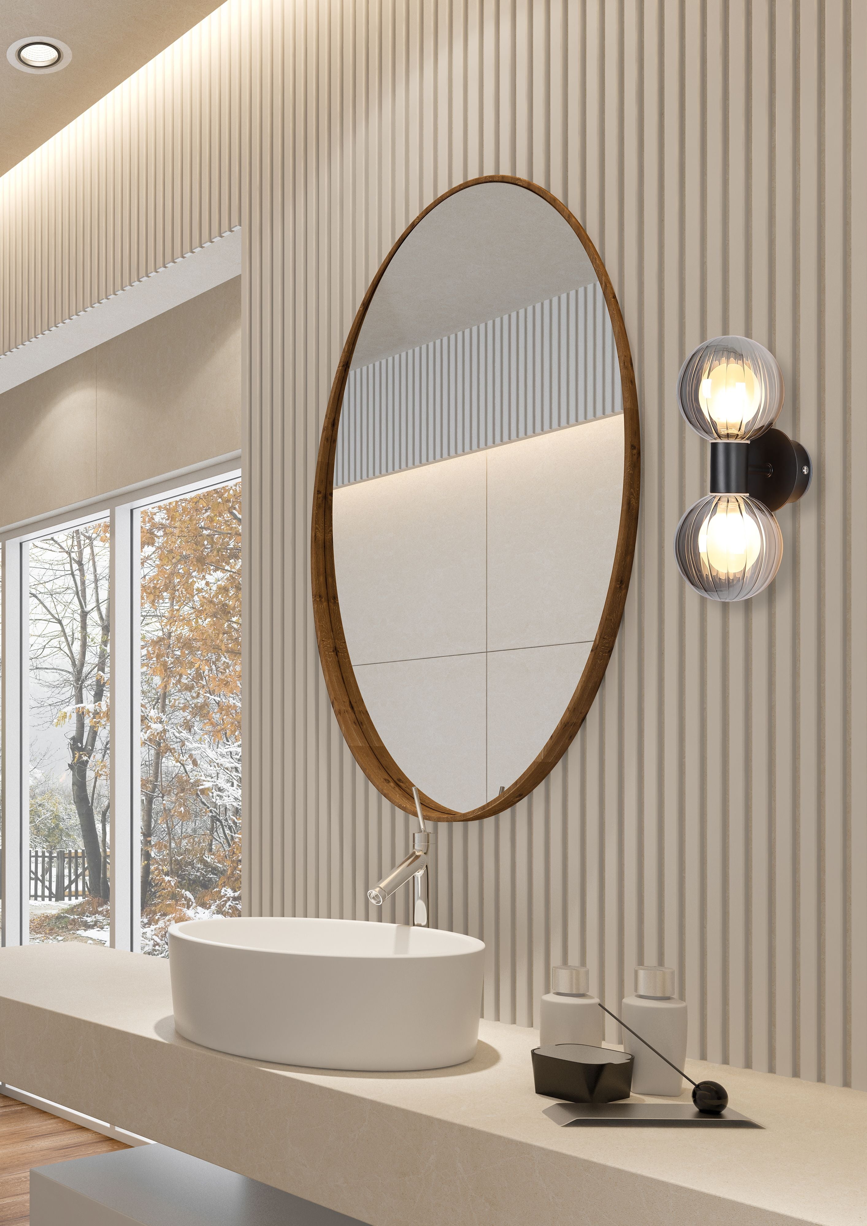 Searchlight Luminsphere 2 Light Wall Light in matte black mounted beside an oval mirror in a bathroom with wood panelling and a window